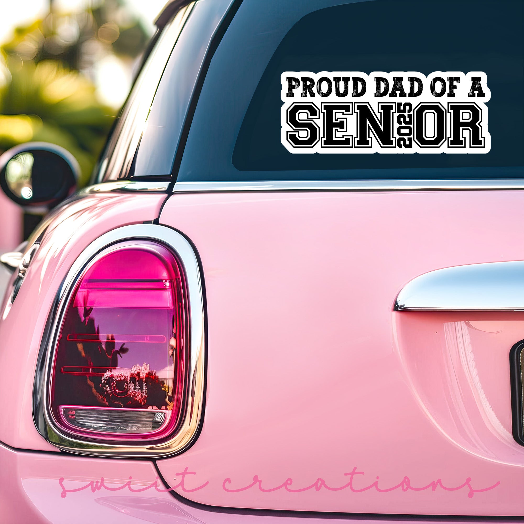 a pink car with a sticker that says proud dad of a senior
