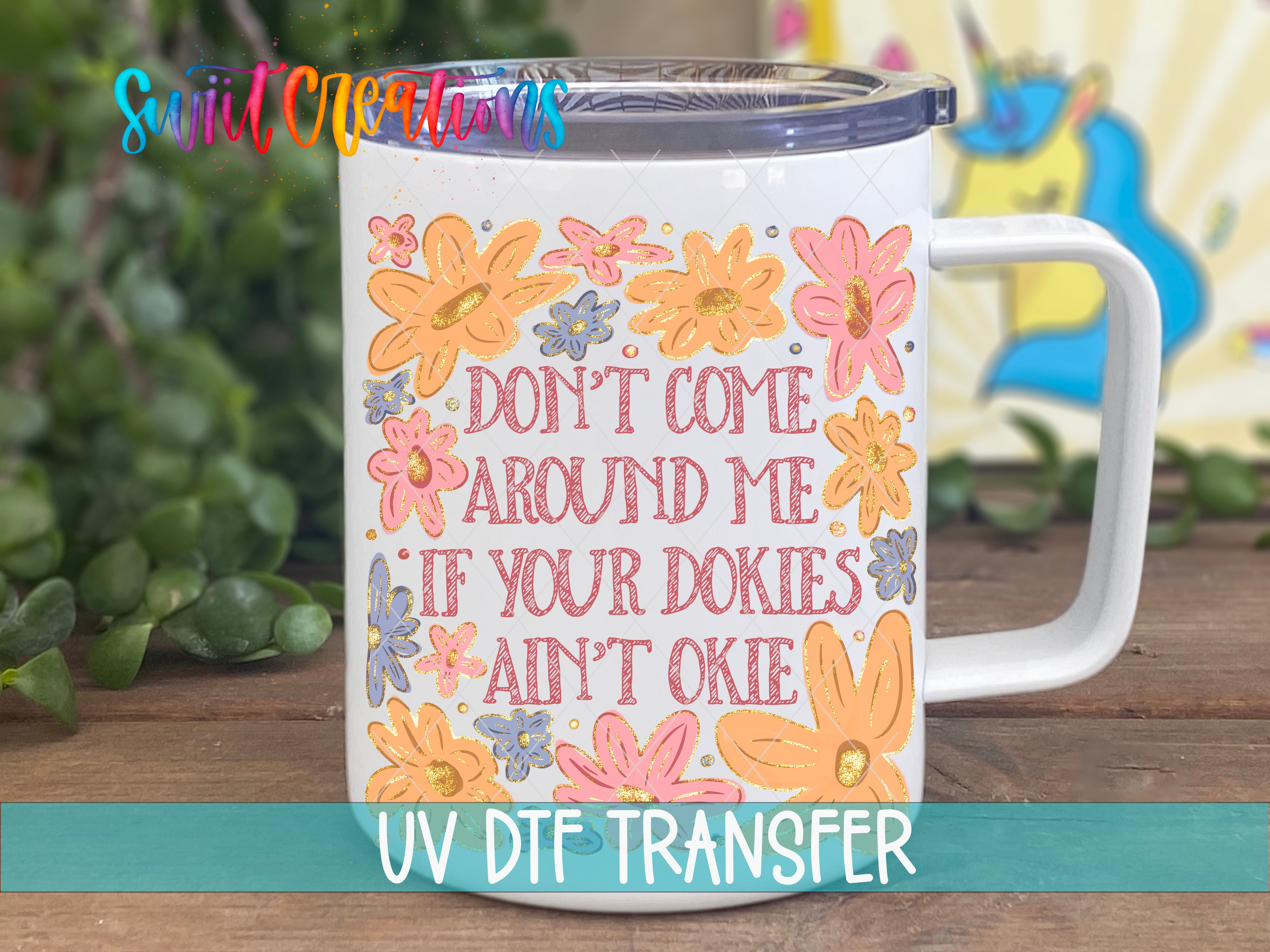 A white mug with a colorful floral design and text printed on it.