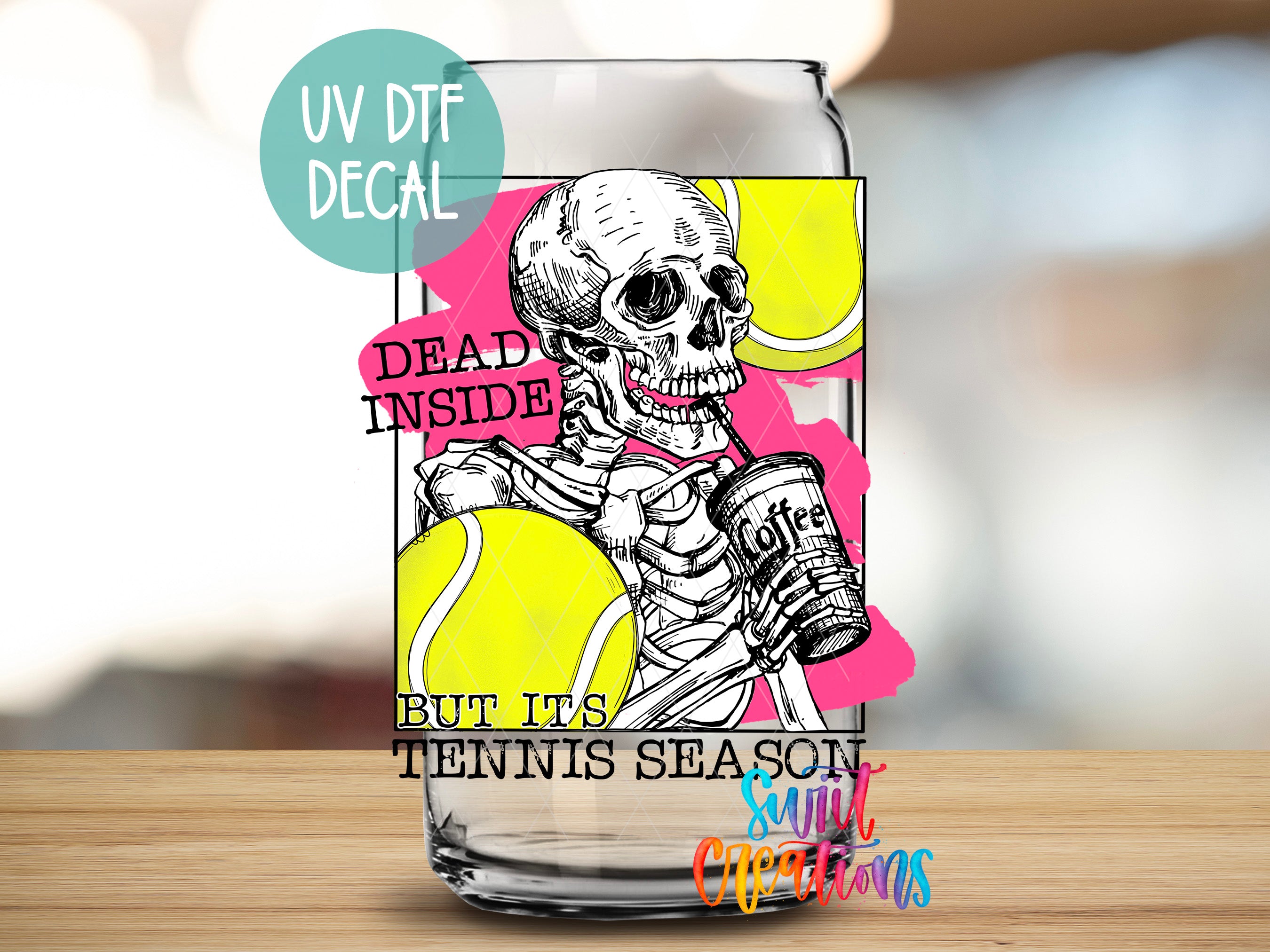 a glass with a picture of a skeleton holding a tennis ball