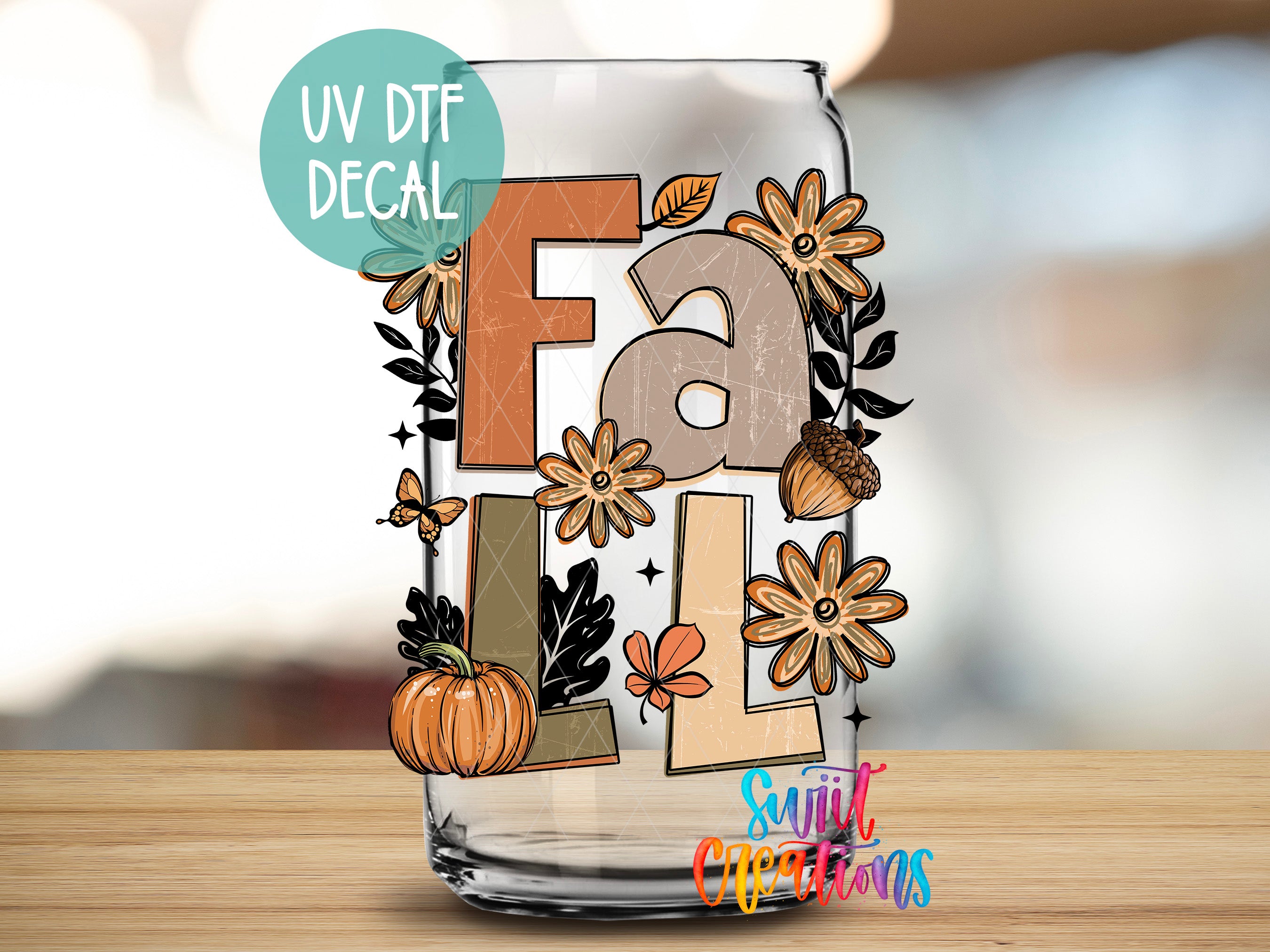 A glass jar with a UV decal featuring the word "Fall" surrounded by autumn-themed elements such as flowers, leaves, and a pumpkin.