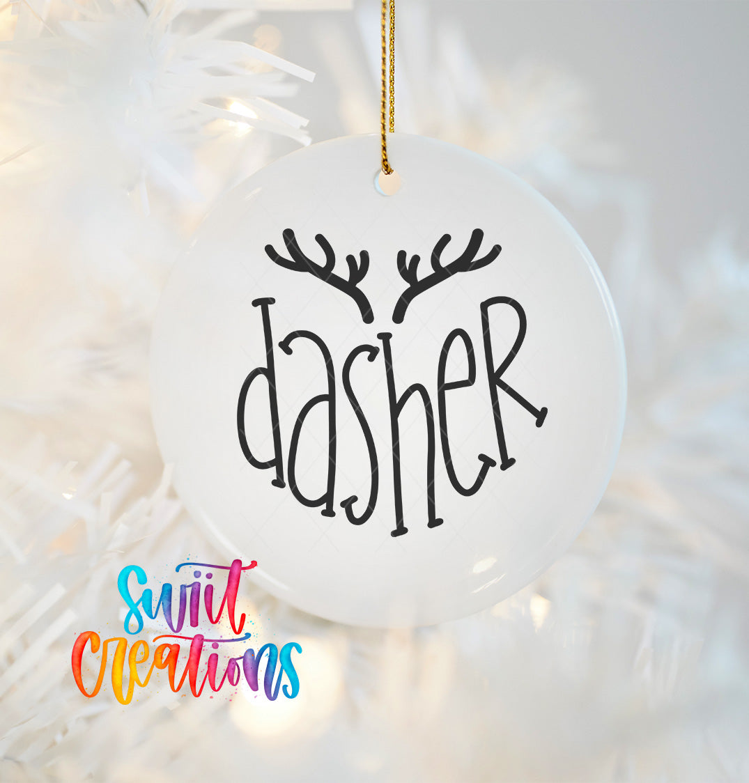 A white ornament with the word "dasher" written on it, hanging on a Christmas tree.