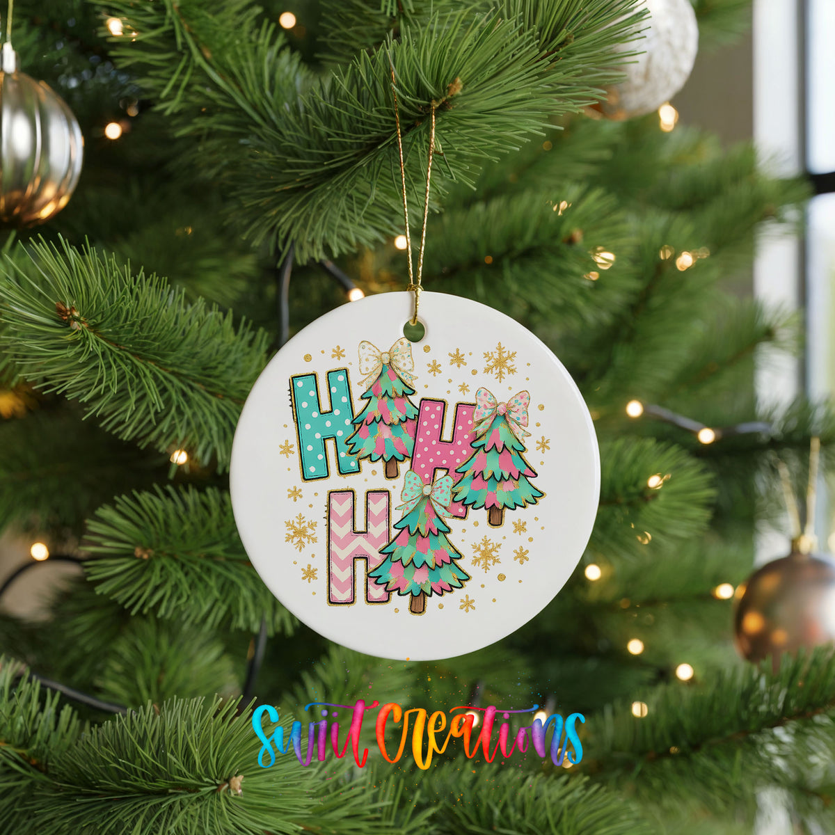 A white Christmas tree ornament with colorful letters spelling "HUH" hanging from a tree branch.