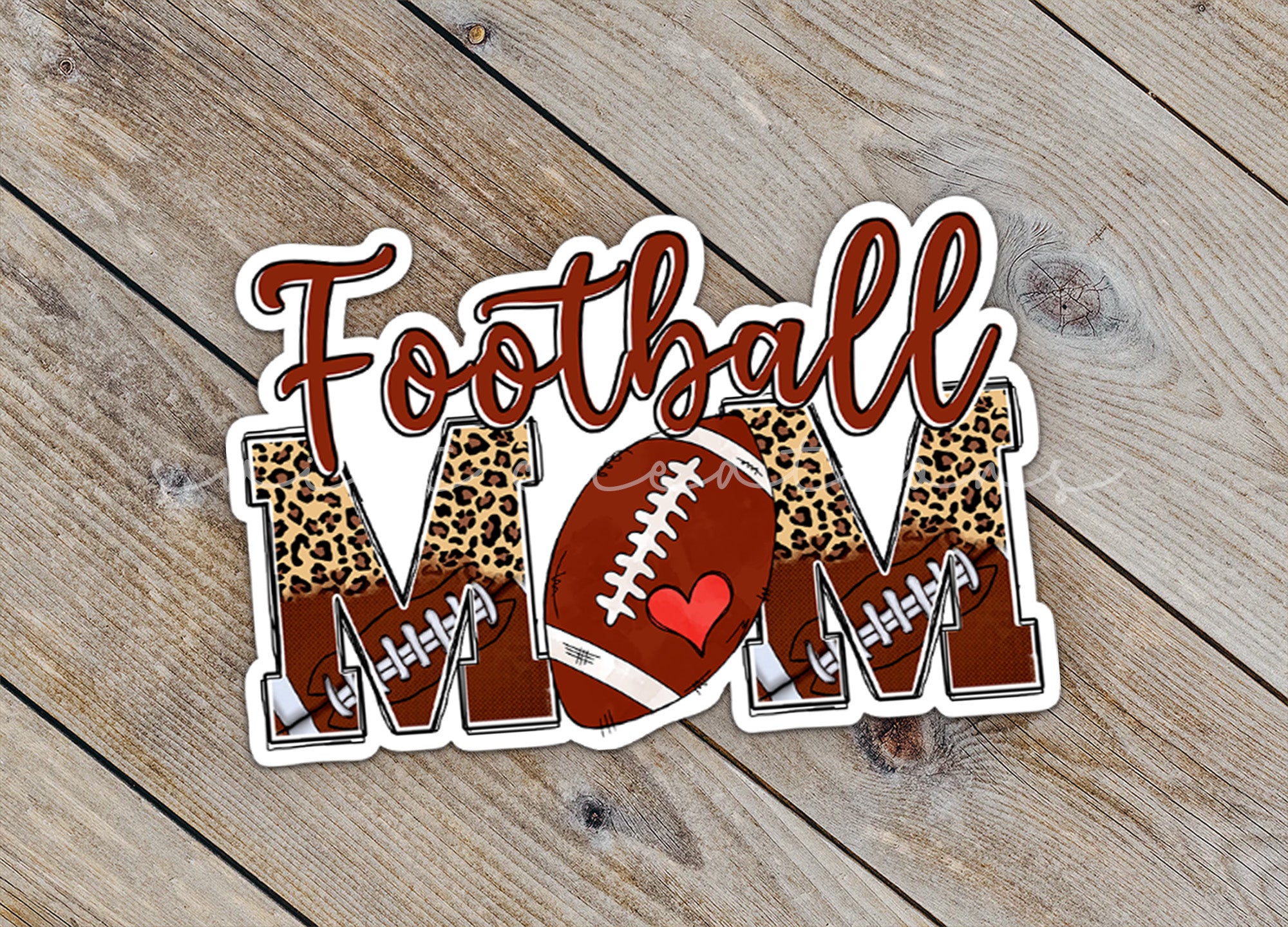 a football mom sticker on a wooden surface