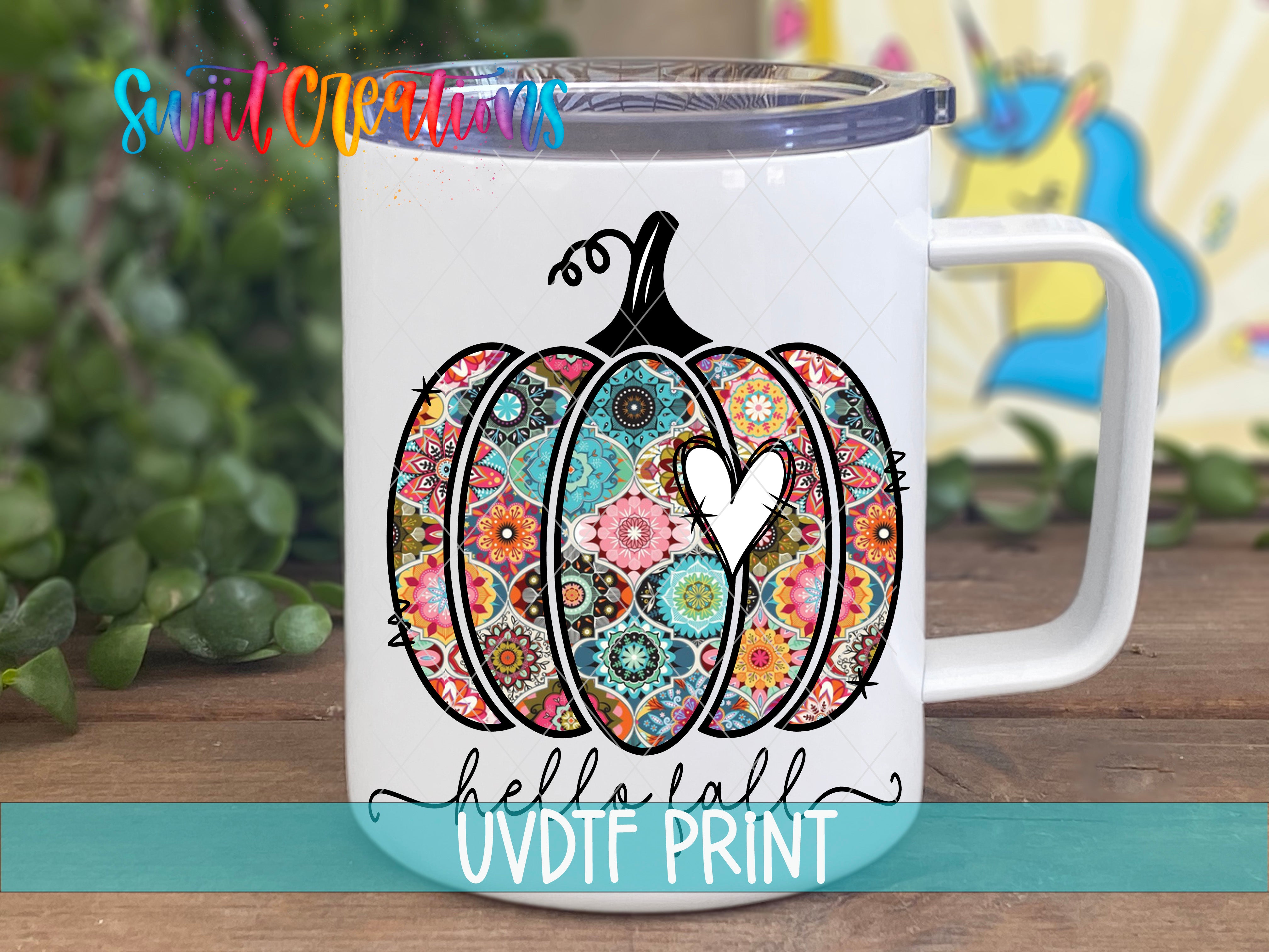 A white ceramic mug with a colorful pumpkin design and the text "Hello! UVDF Print" printed on it.