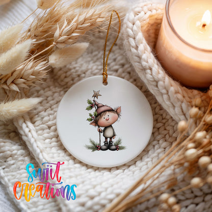 A white ceramic ornament featuring a cartoon elf wearing a hat and holding a star, surrounded by dried flowers and a lit candle.