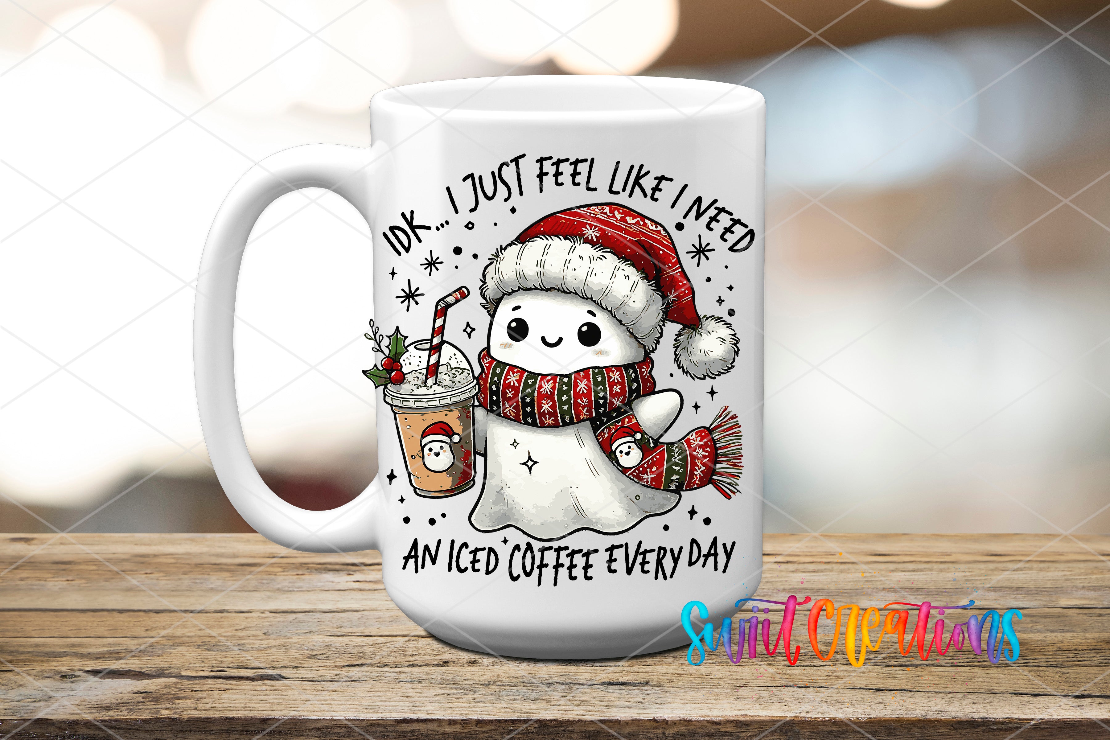 A white mug with a cartoon image of a ghost wearing a Santa hat and scarf, holding an iced coffee, and surrounded by snowflakes and stars.