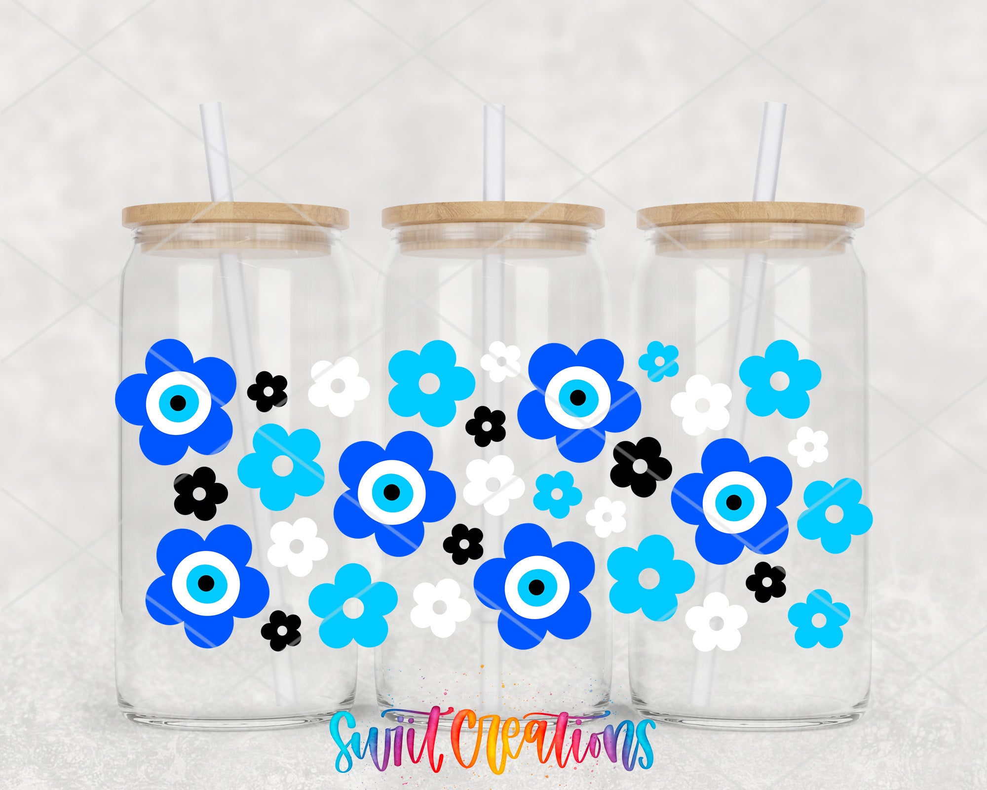 Three glass jars with wooden lids, each containing a blue flower design with black and white accents.