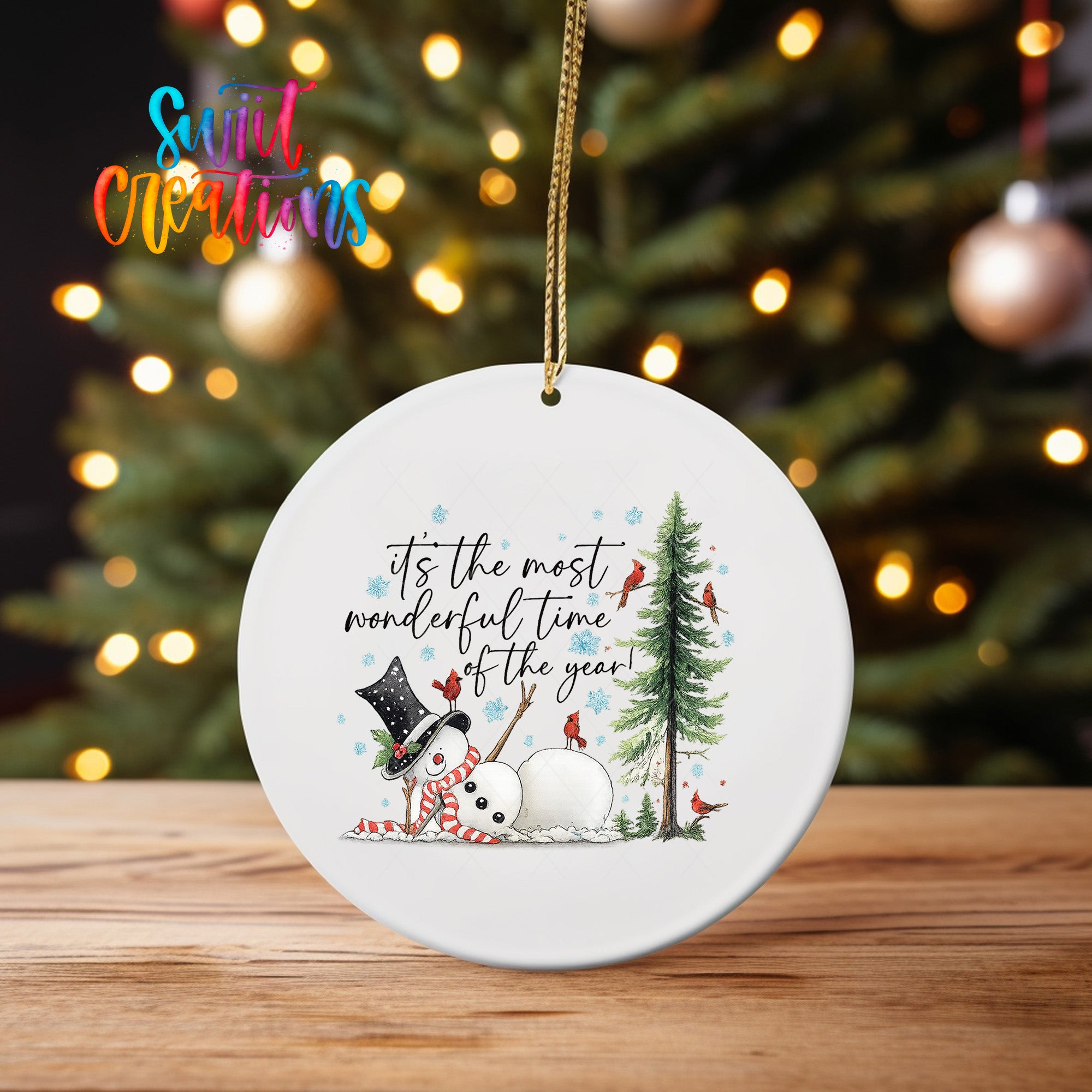 A white ornament with a snowman and a pine tree, along with the text "It's the most wonderful time of the year!"