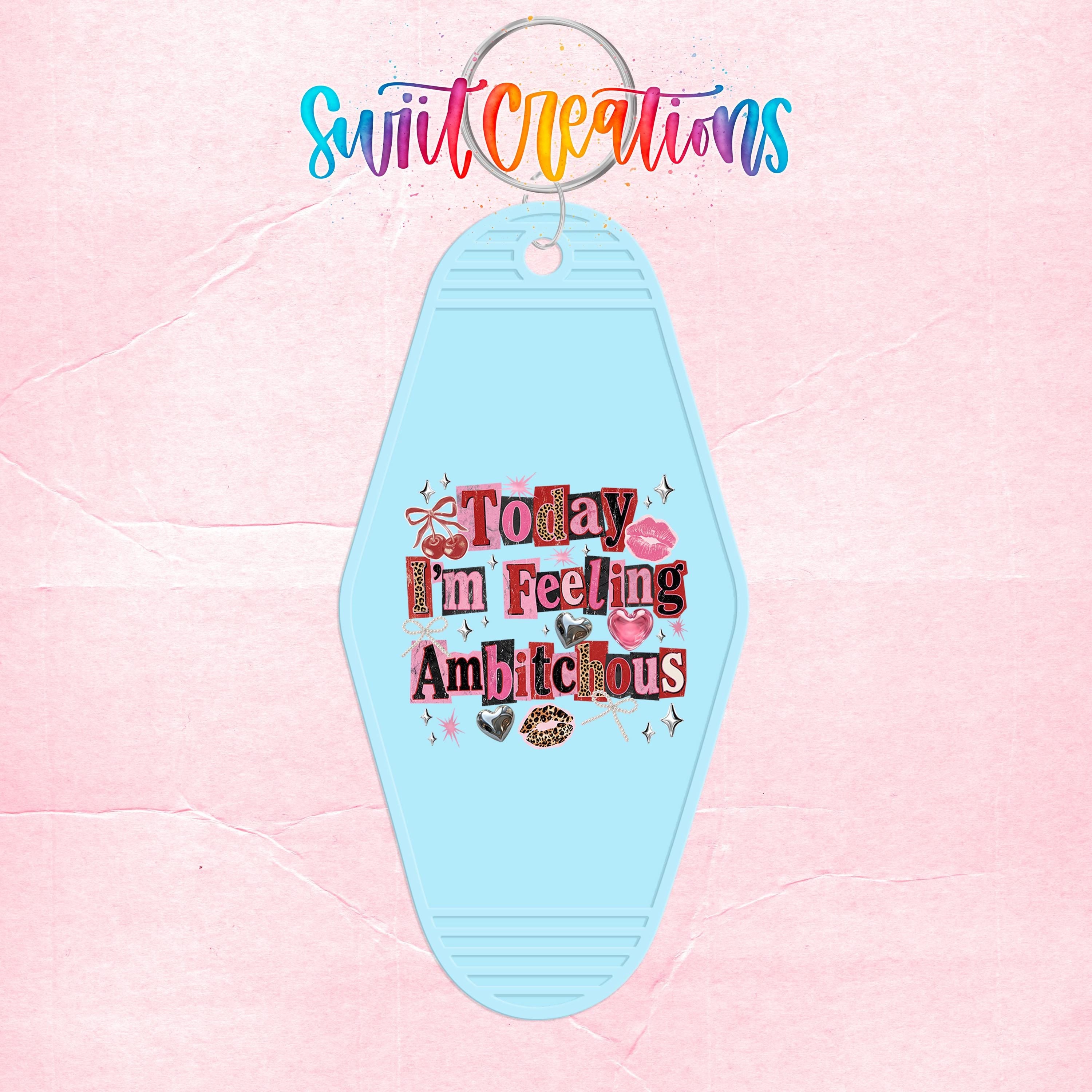 A keychain with a light blue color and a colorful, whimsical design featuring text and illustrations.