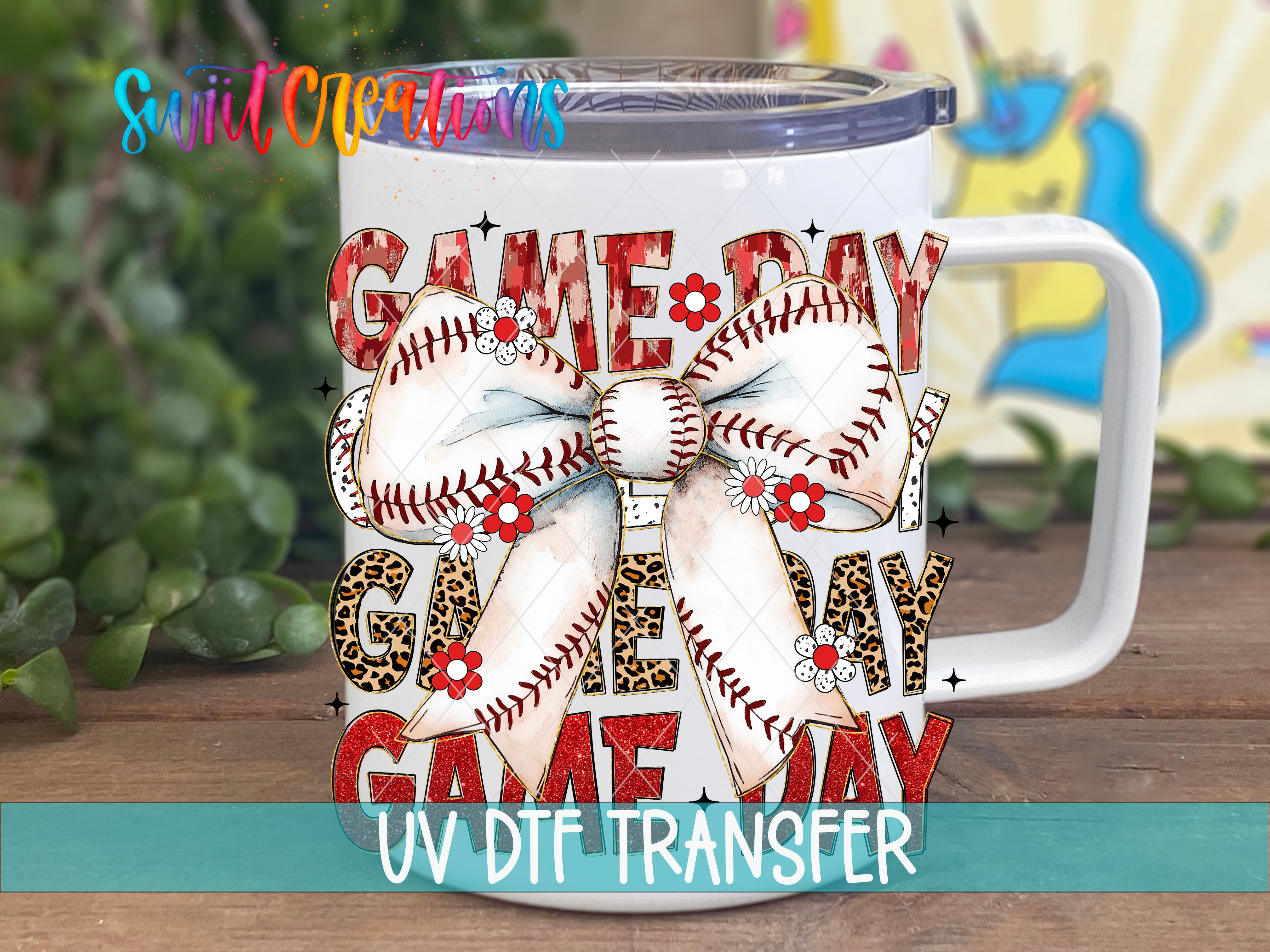 A white mug with a baseball-themed design, including a large bow and the text "GAME DAY" in a colorful, playful style.