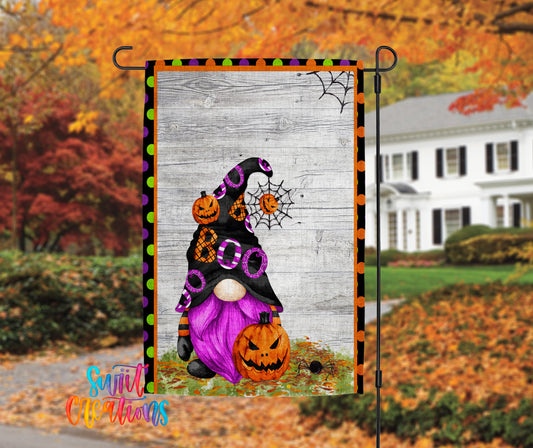 A Halloween-themed banner featuring a purple gnome with a black hat and a pumpkin, set against a backdrop of autumn foliage and a white house.