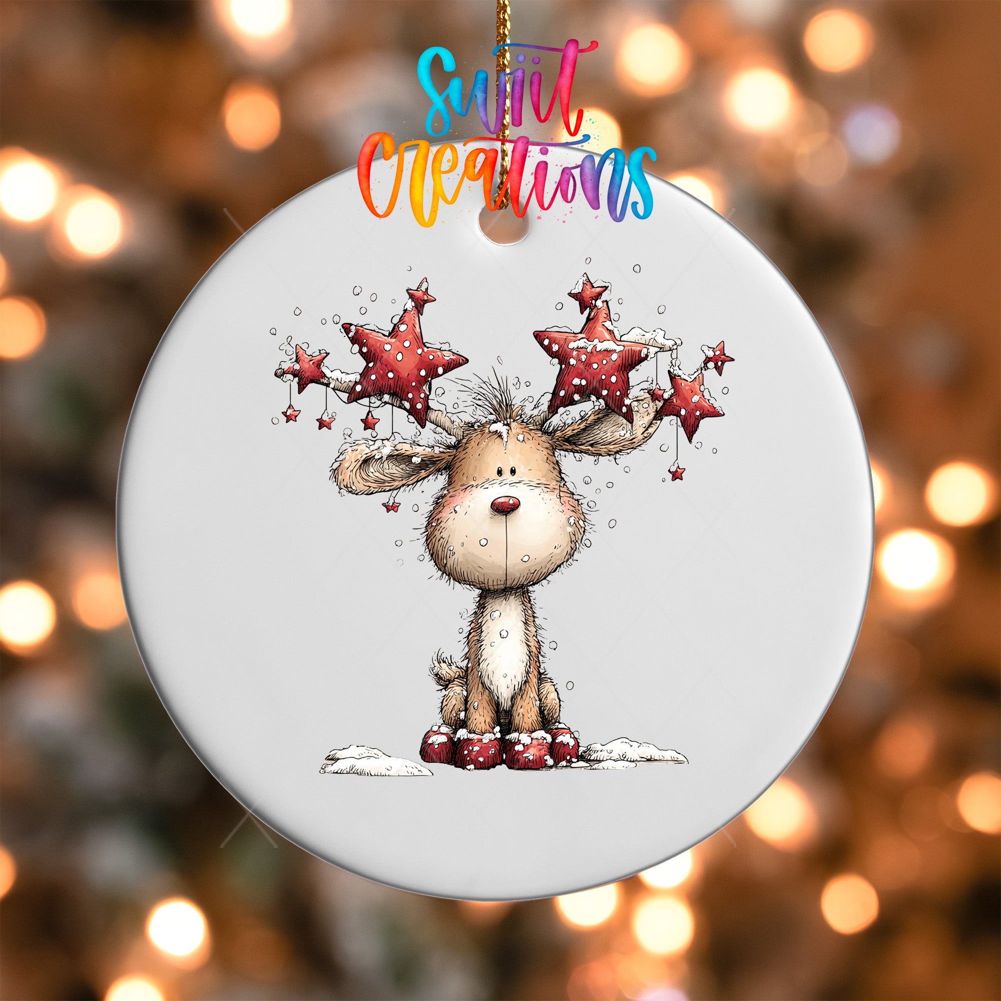 A white ornament with a cartoon reindeer and stars hanging from it.