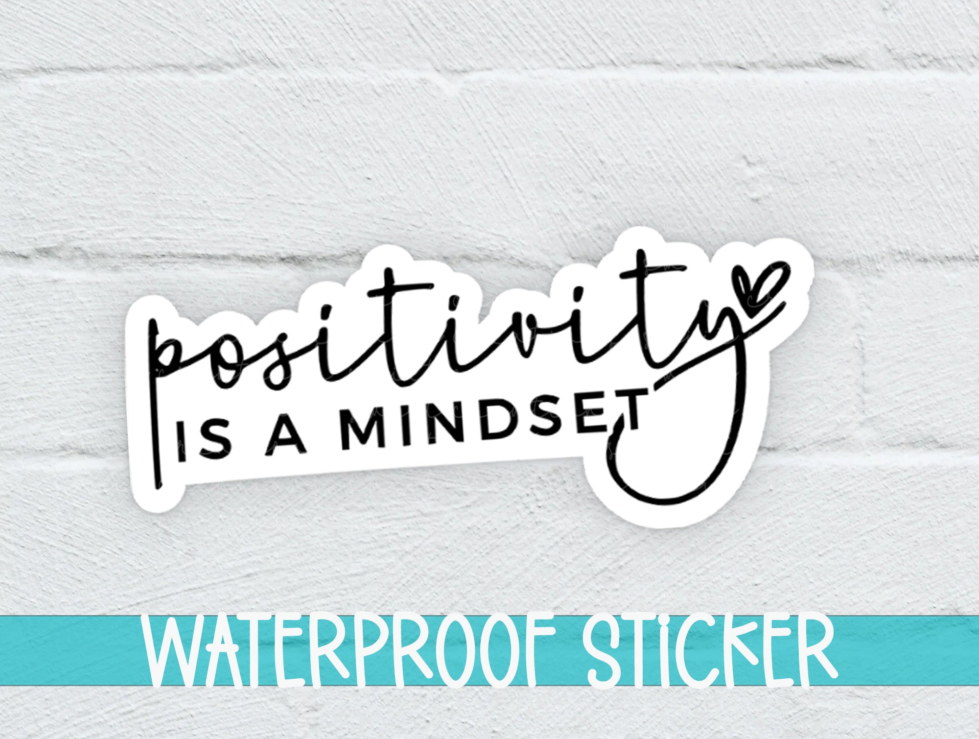 a white brick wall with a sticker saying positivity is a mindset