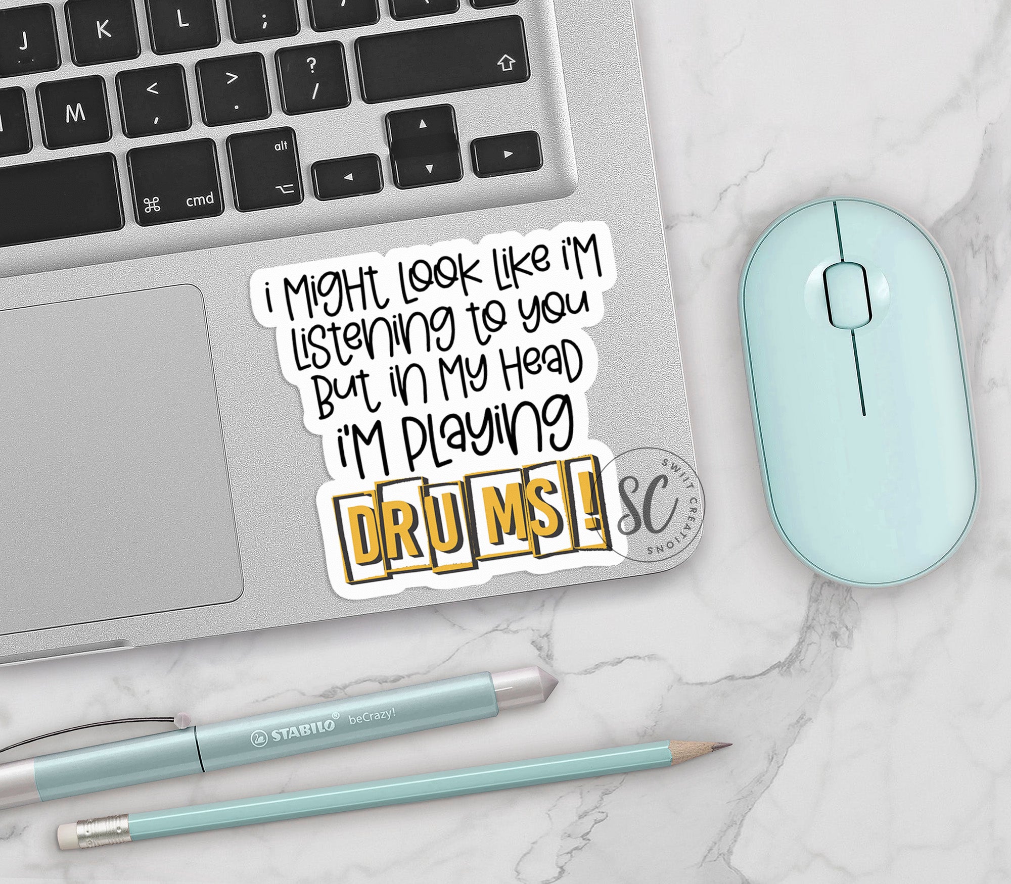 a laptop with a sticker on it next to a mouse