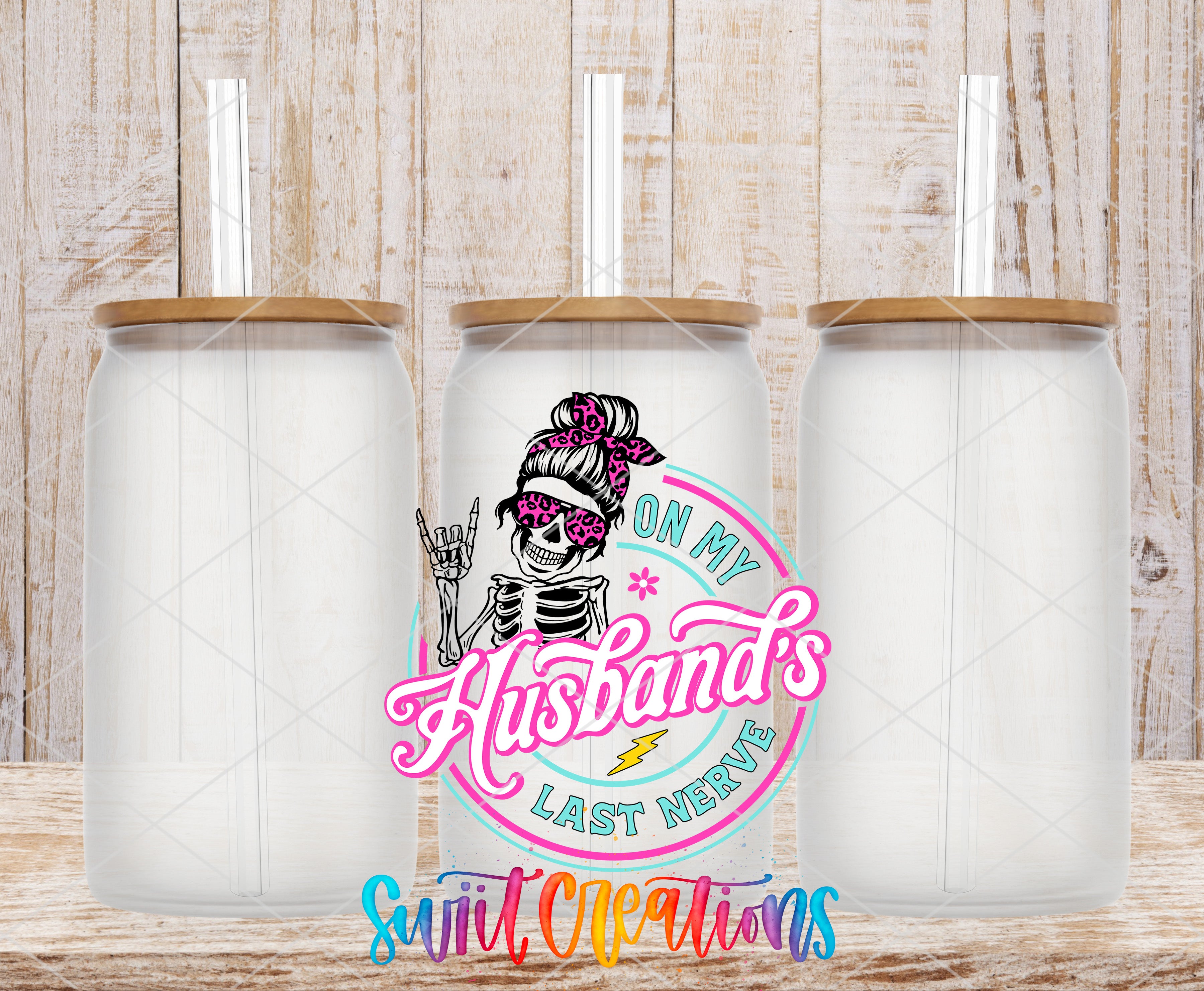 three clear glass jars with lids, arranged in a row against a wooden background. The jars have a unique design with a skeleton figure and a pink and blue color scheme. The text "On My Husband's Last Nerve" is displayed prominently in the center of the image, suggesting a humorous or playful theme related to the jars.