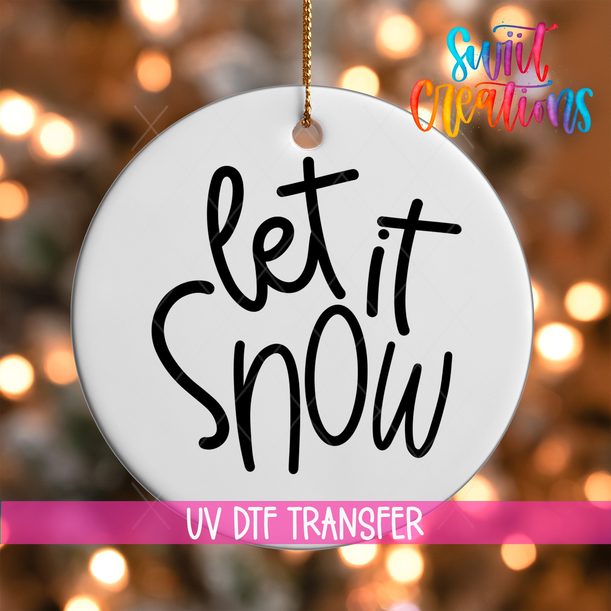 A white circle ornament with the text "let it snow" written on it, hanging against a background of colorful lights.