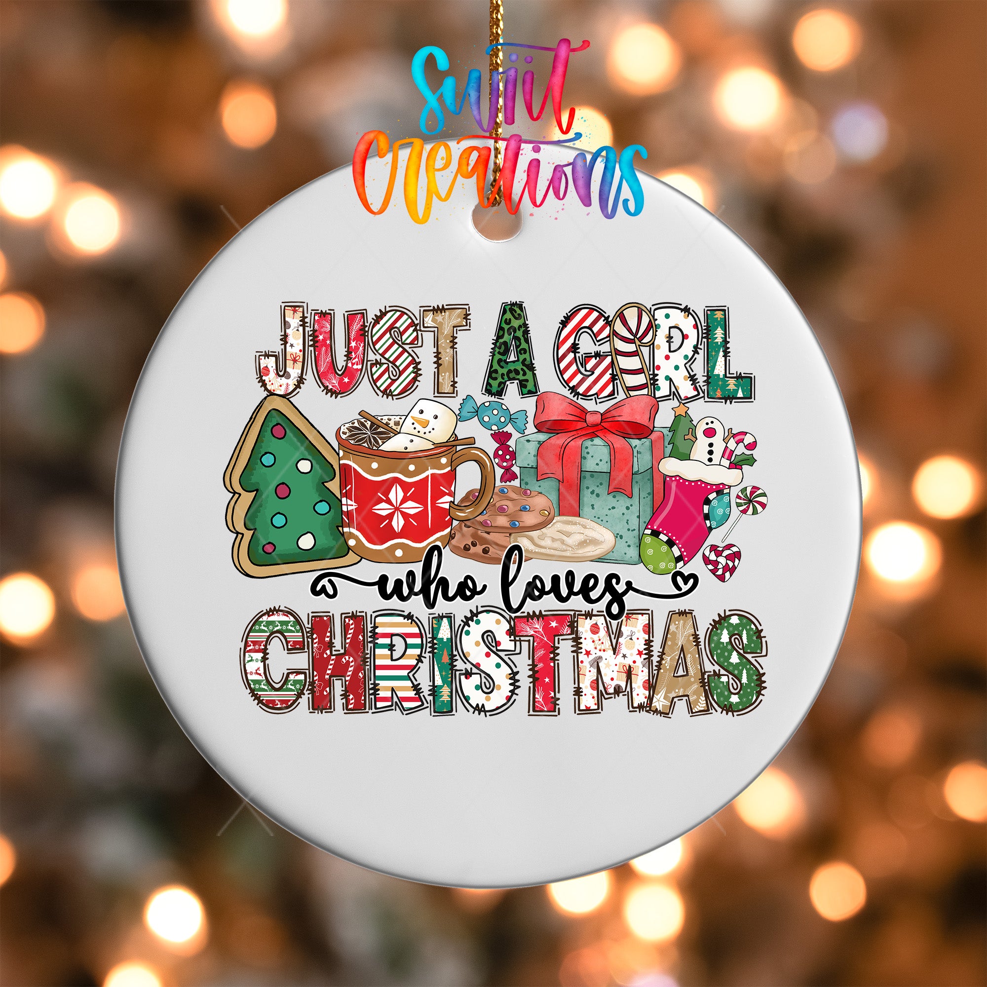 A white ornament with a colorful design featuring Christmas-themed elements, such as a Christmas tree, presents, and a mug with a hot beverage. The text on the ornament reads "Just a girl who loves Christmas".