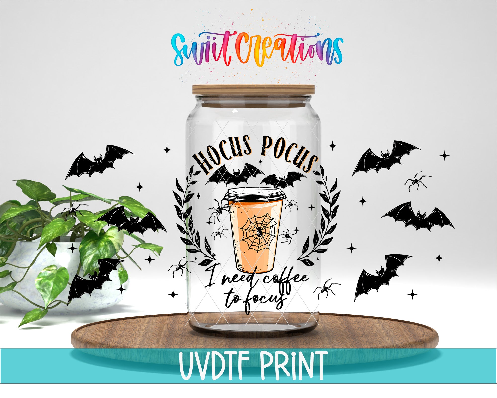 a clear glass jar with a Halloween-themed design, including a spider web, bats, and a cup of coffee. The jar is placed on a wooden surface, and there is a plant in the background. The text "Swift Creations" is written above the jar, and "I need coffee to focus" is written below the spider web. The image is described as a collage of multiple images, and the text "UVDTFRINT" is written at the bottom.