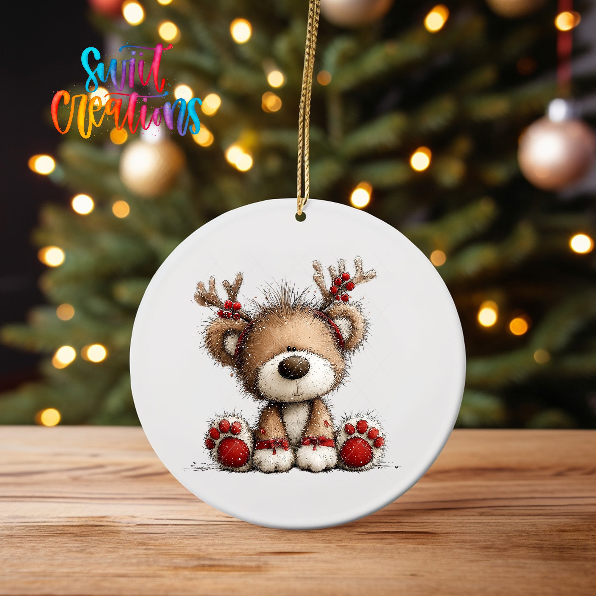A white ceramic ornament featuring a cute reindeer with antlers and red berries, sitting on a wooden surface in front of a blurred Christmas tree with twinkling lights.