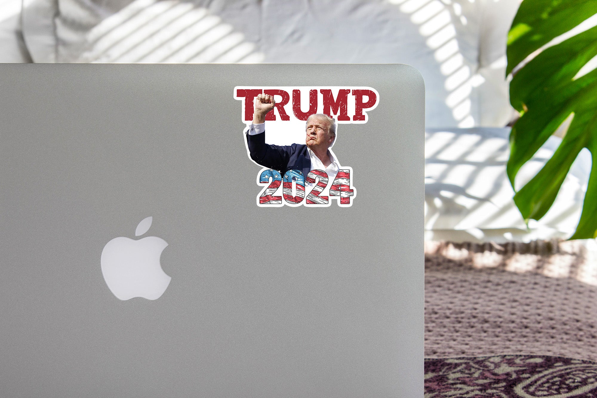a laptop with a sticker of donald trump on it