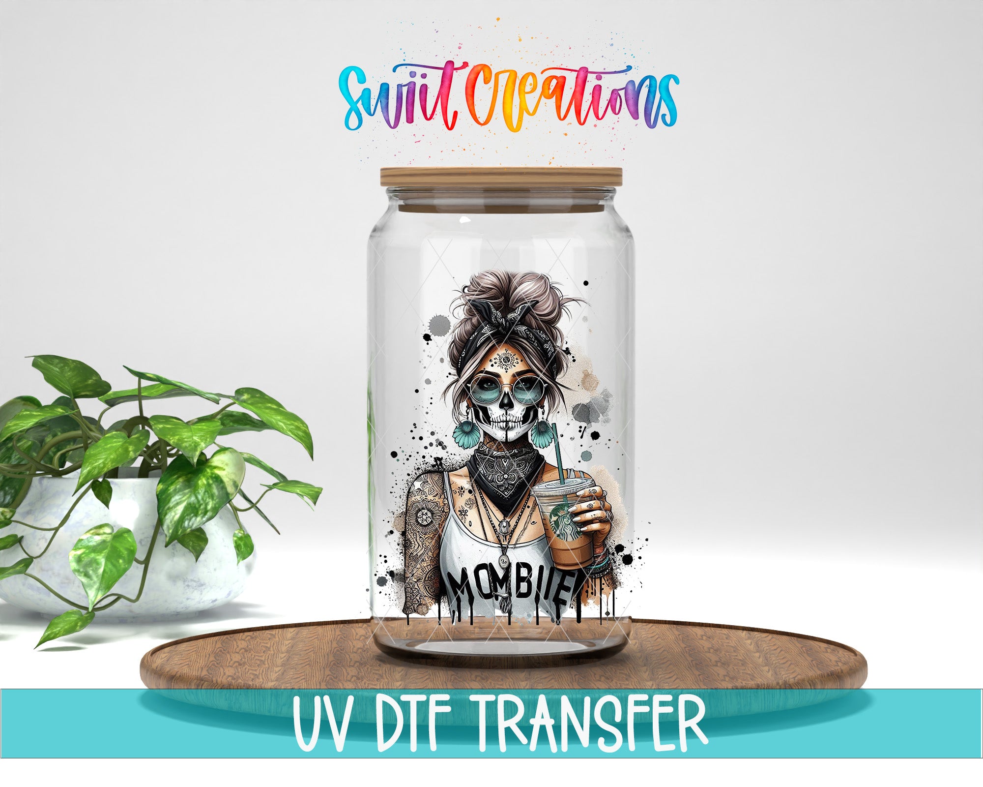 a glass jar with a skull design and the word "MOMBIE" printed on it, placed on a wooden surface.