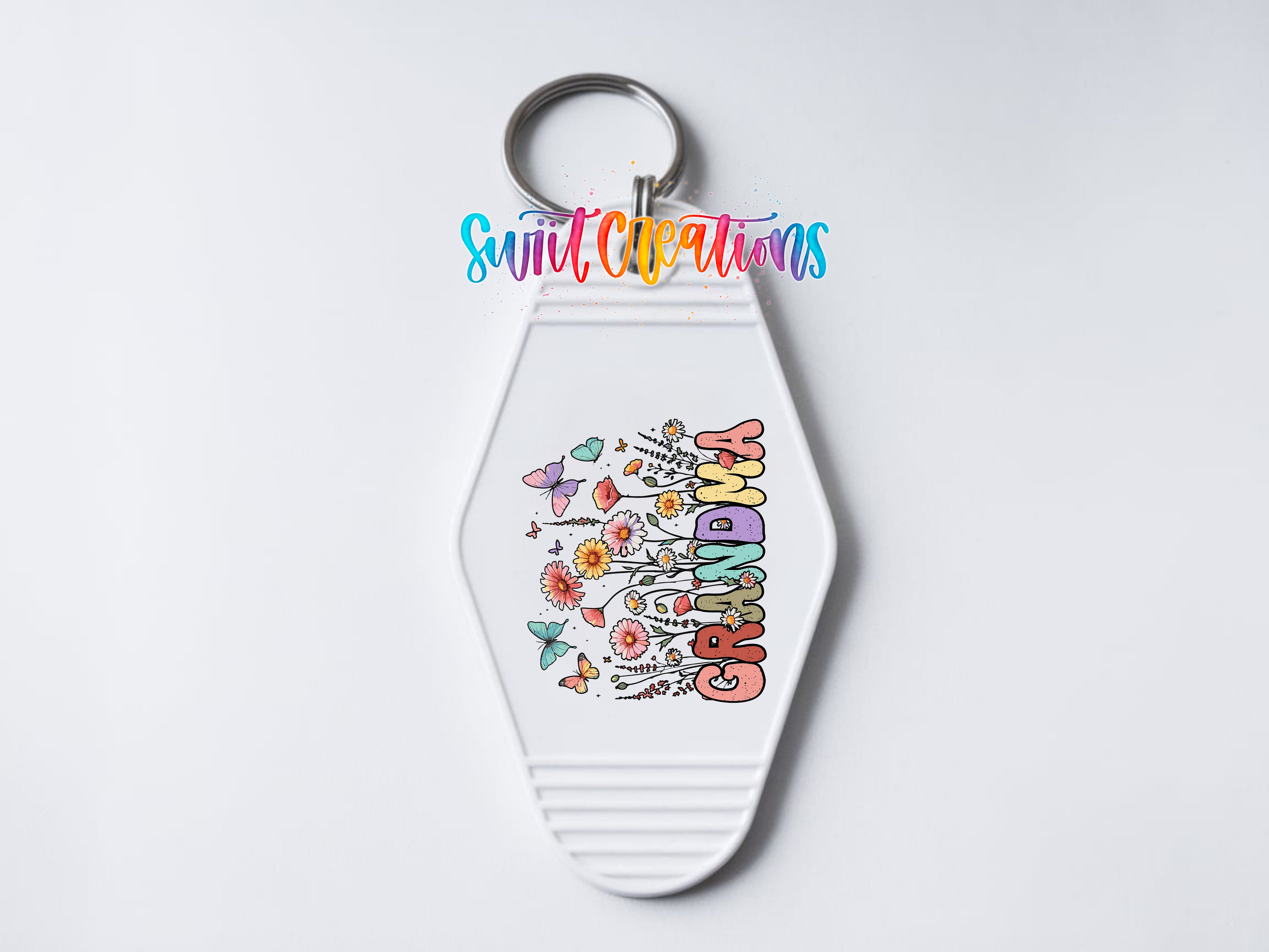 A keychain with a colorful floral design and the word "GRANDMA" printed on it.