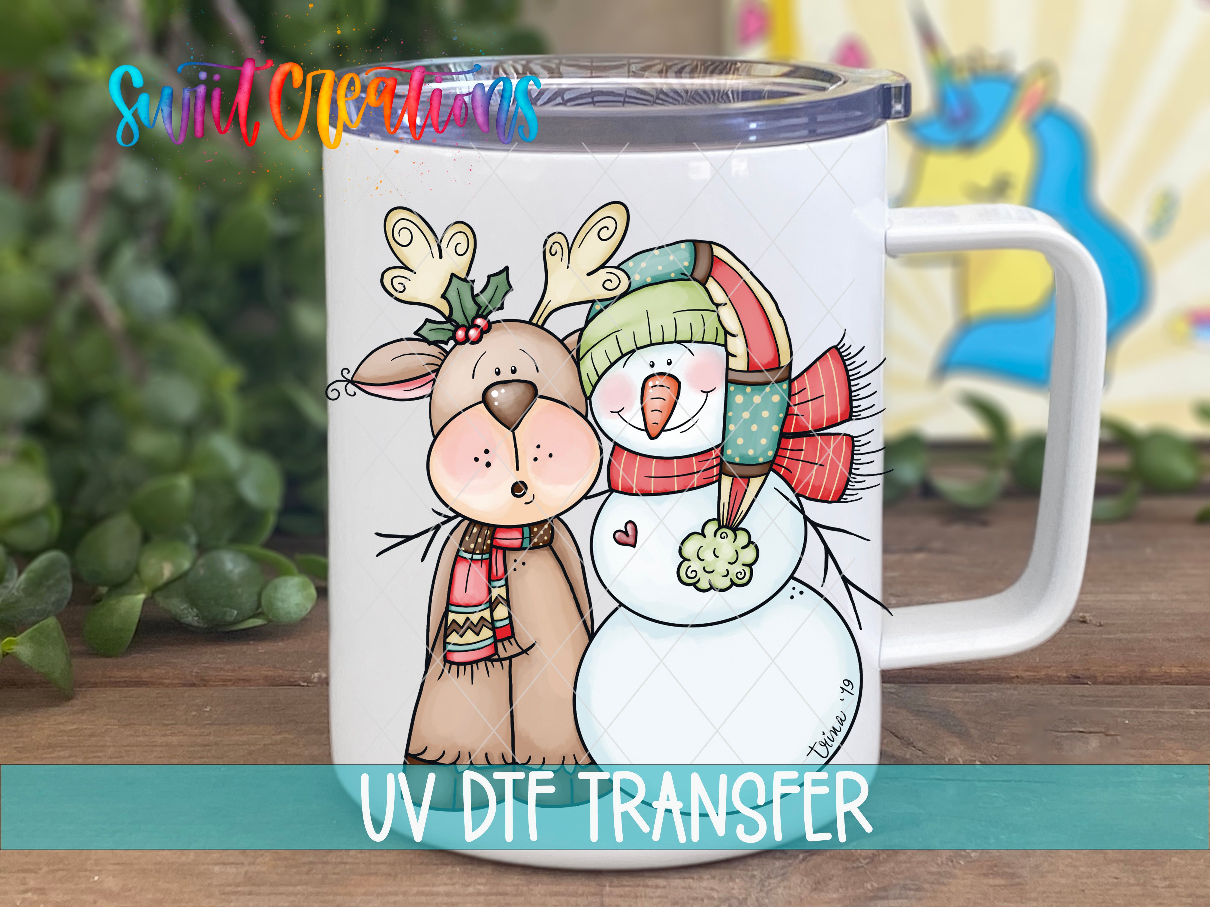 A mug with a cartoon illustration of a reindeer and a snowman, along with the text "UV Dtf Transfer".