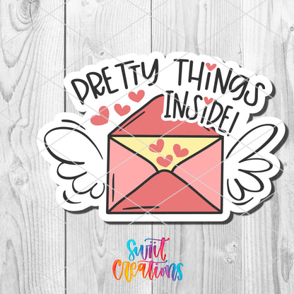 a pink envelope with hearts on it and the words pretty things inside