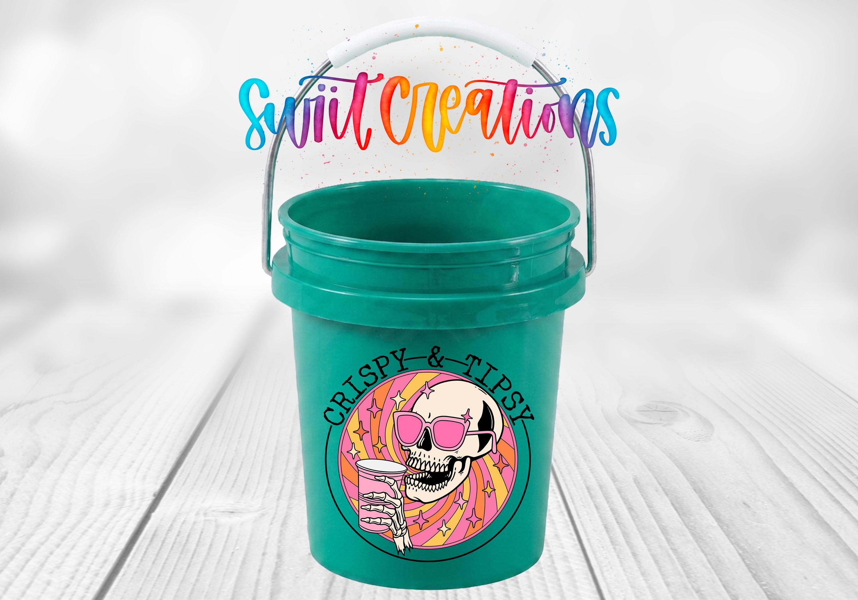 A green bucket with a skull and sunglasses design, along with the text "Crispy & Tipsy" written on it.