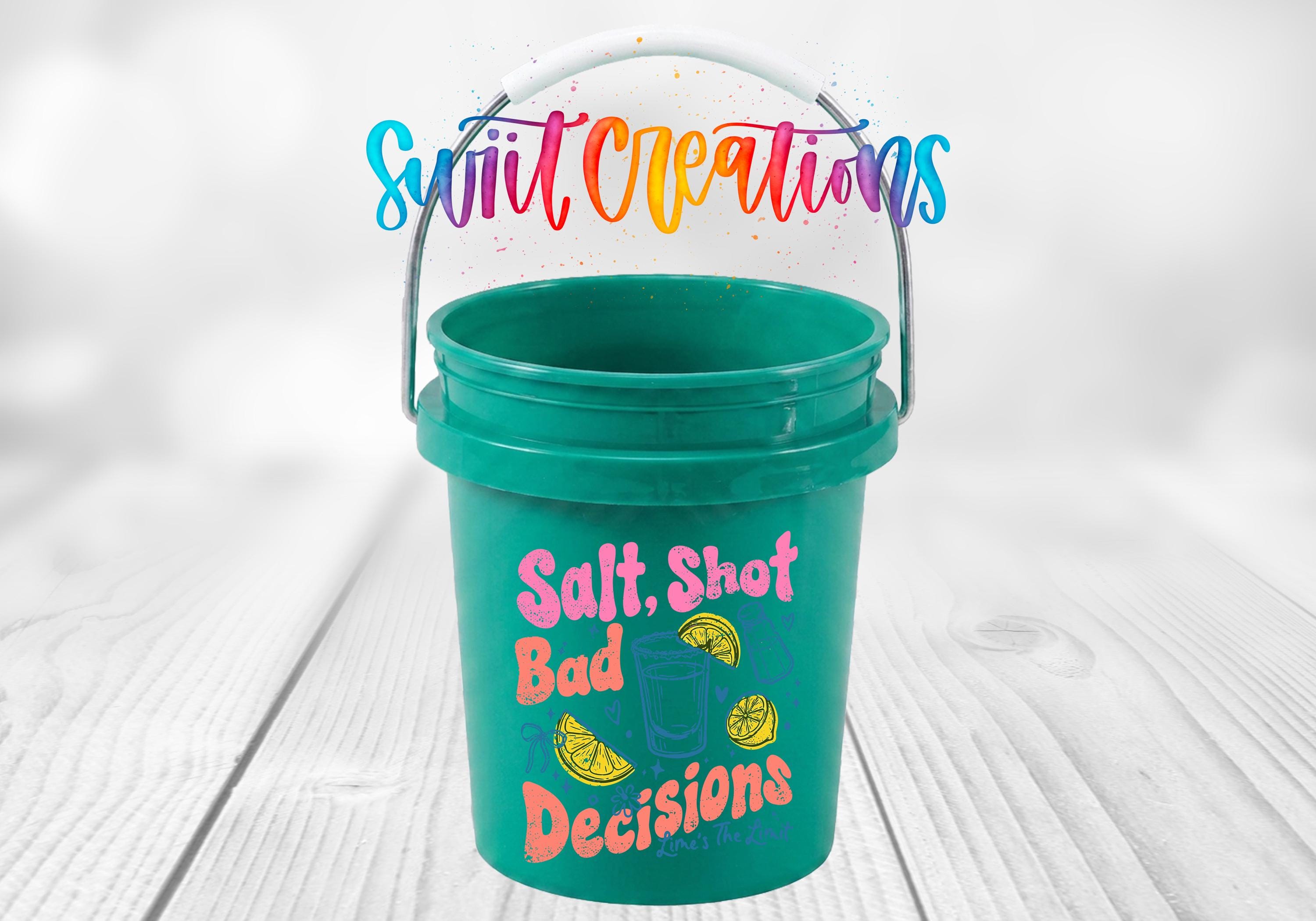 A green plastic bucket with a handle, featuring a colorful and playful design with text and illustrations.