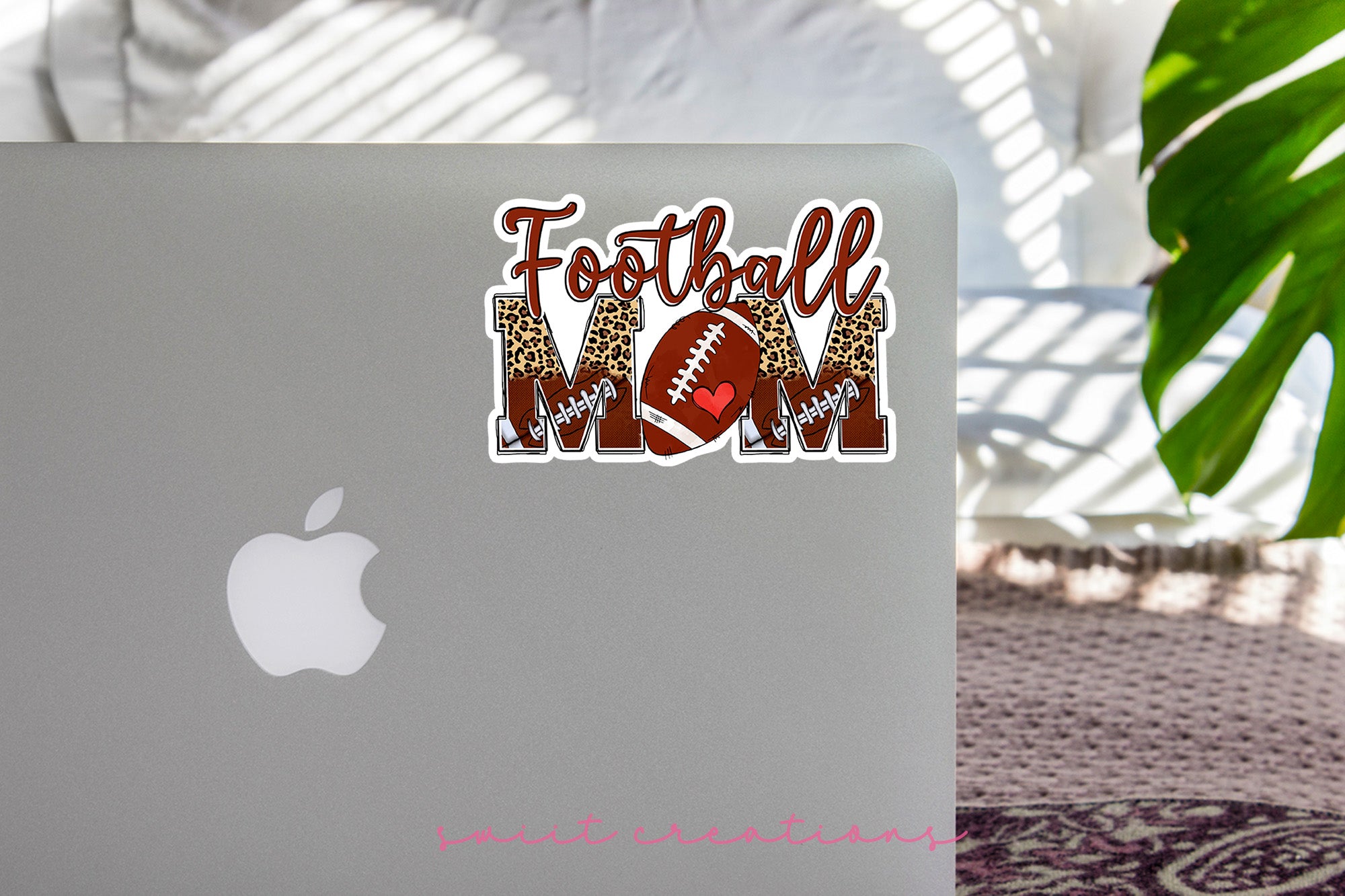 a laptop with a football mom sticker on it