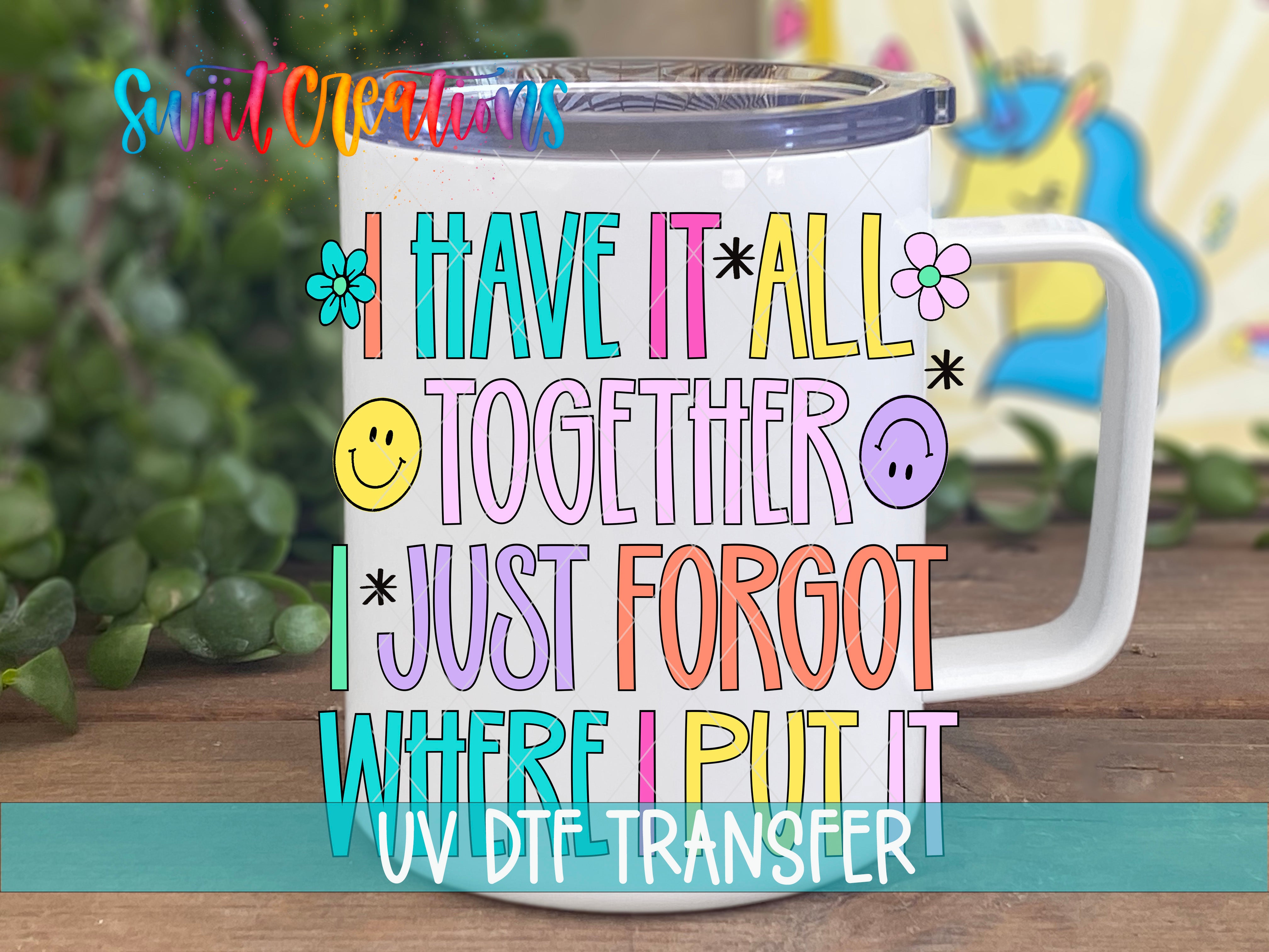 A white mug with colorful text and illustrations on it, placed on a wooden surface.