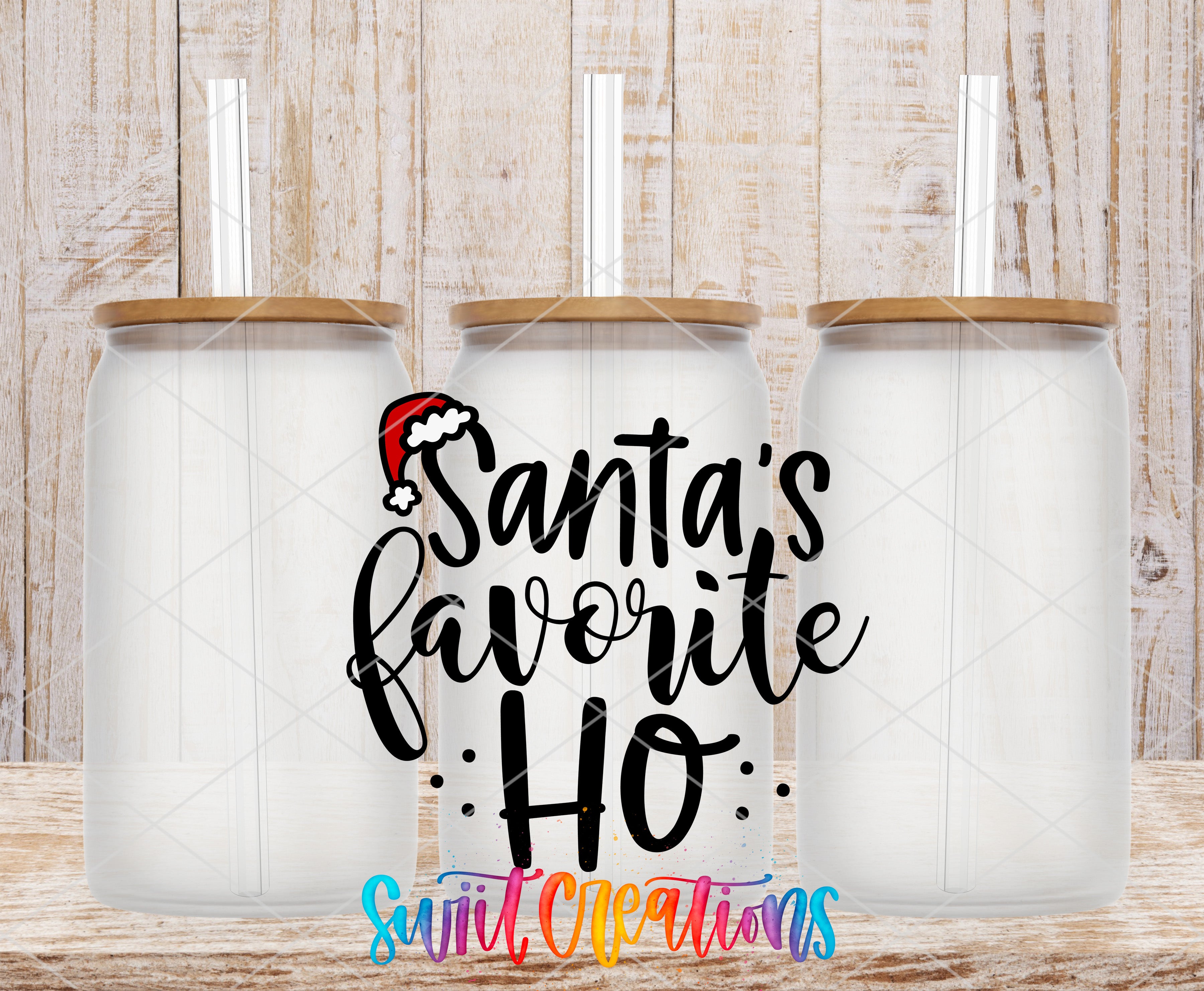 three clear glass jars with wooden lids, arranged in a row against a wooden background. The jars have straws sticking out of the lids. The text "Santa's favorite ho" is written in a stylized font in the center of the image.