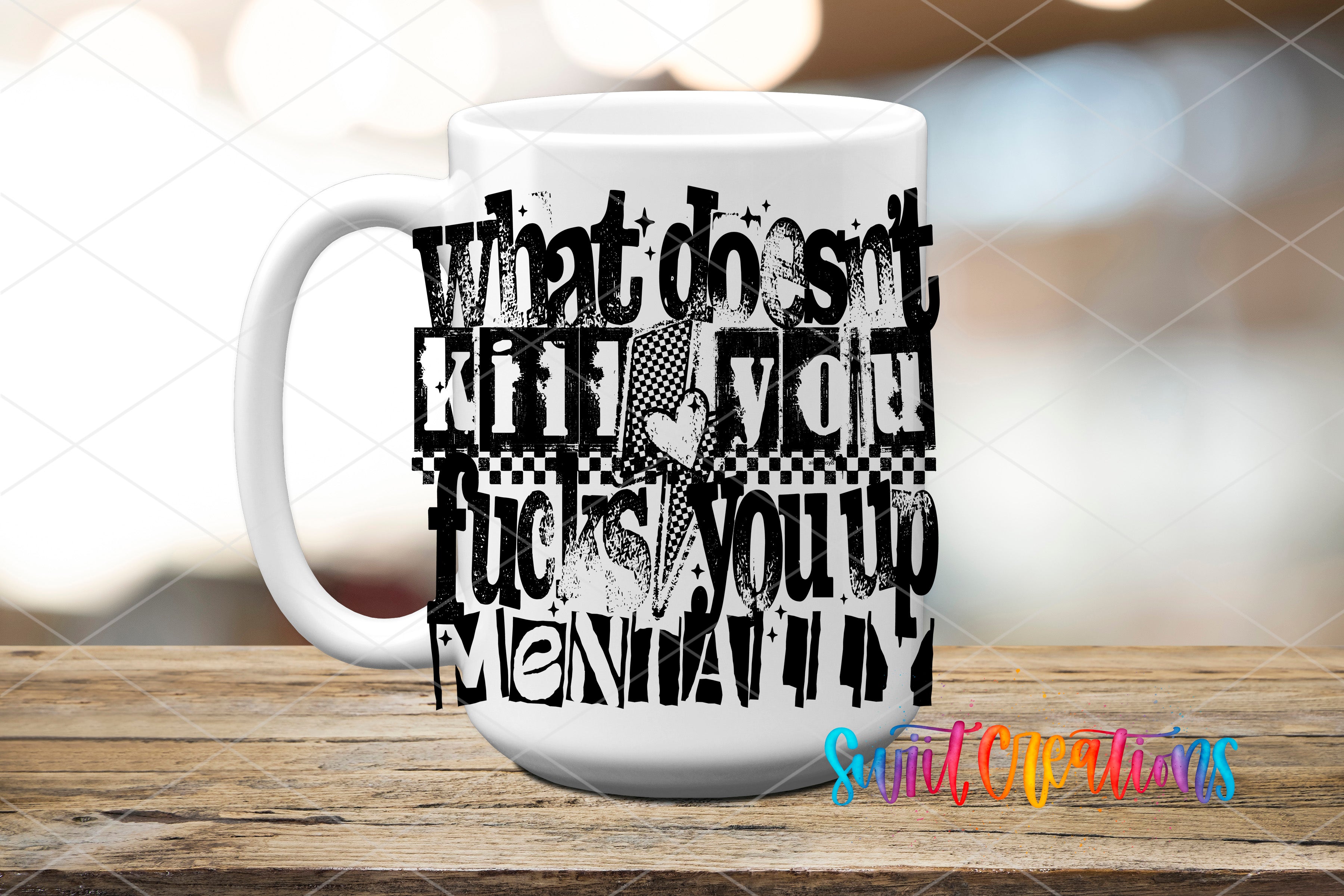 A white mug with black text printed on it, sitting on a wooden surface.