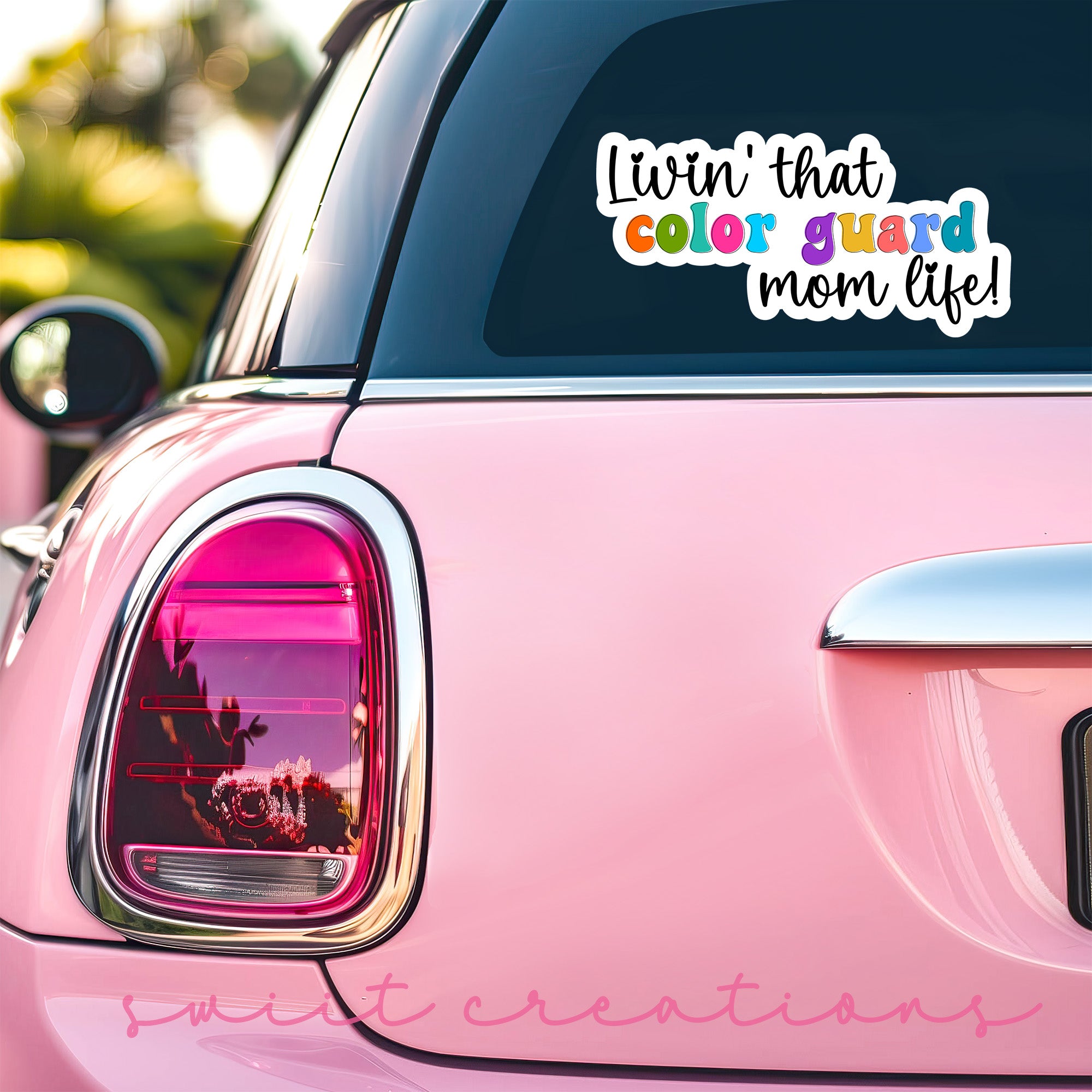 a pink car that has a sticker on it