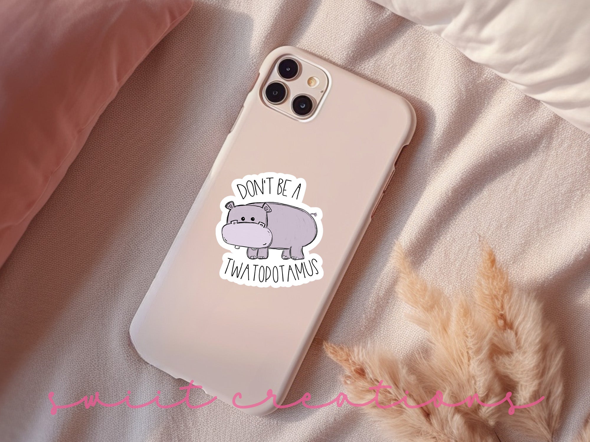 a phone case with a sticker of a hippo on it