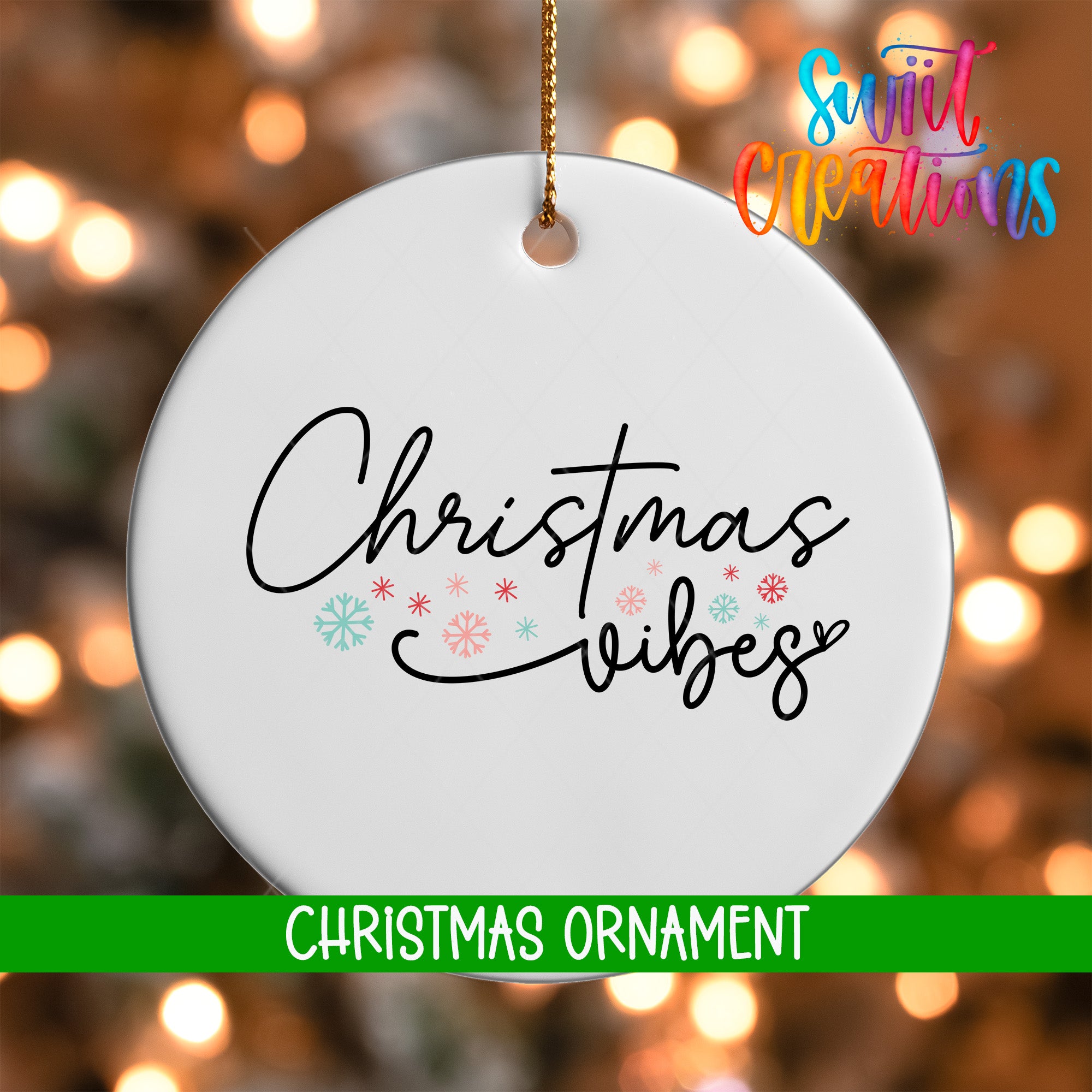 A white Christmas ornament with the text "Christmas Vibes" written on it, hanging against a background of colorful lights.