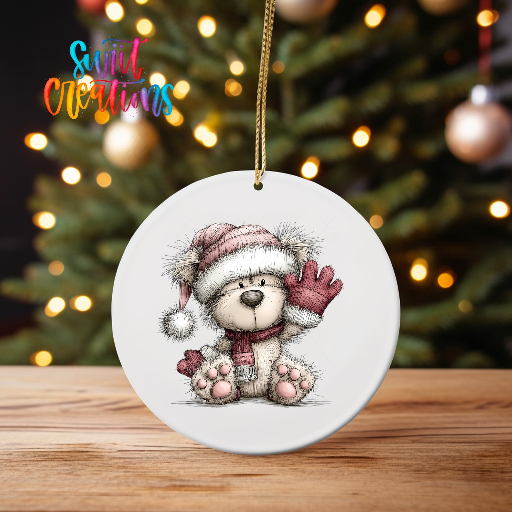 A white ceramic ornament featuring a teddy bear wearing a winter hat and scarf, with a Christmas tree in the background.