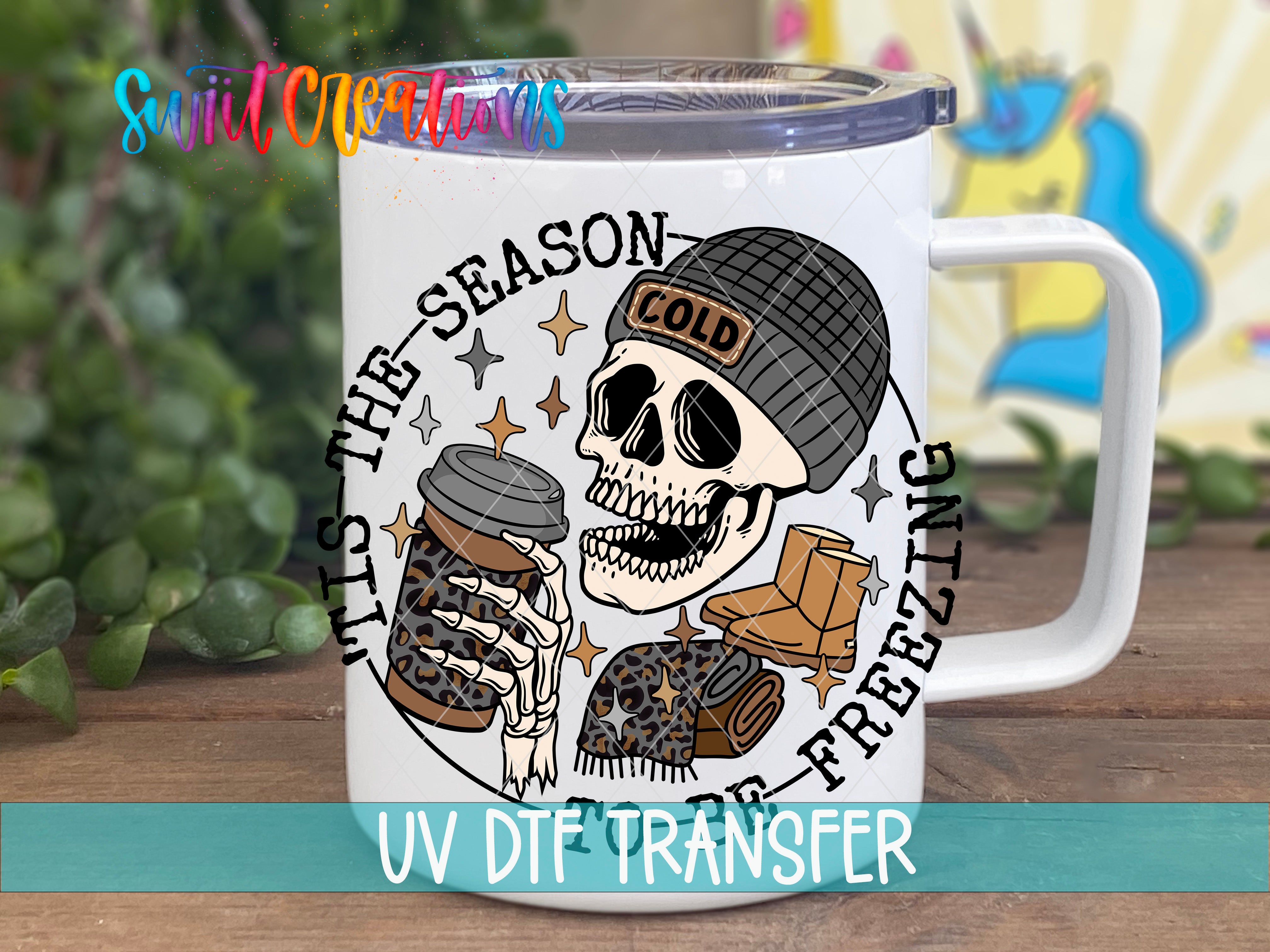 A mug with a skull wearing a beanie and holding a coffee cup, surrounded by stars and text that says "The season is cold".