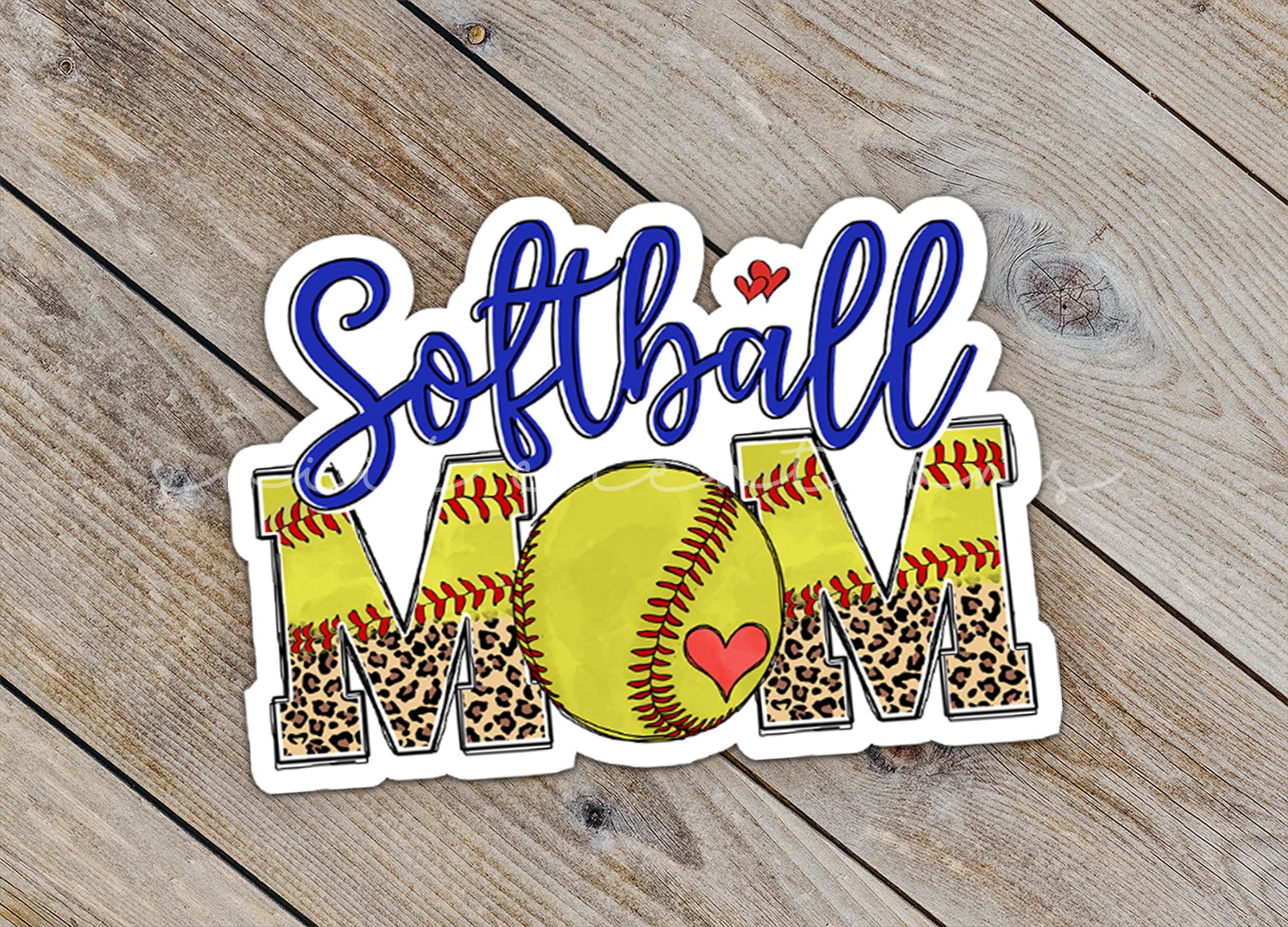 a softball mom sticker sitting on top of a wooden table