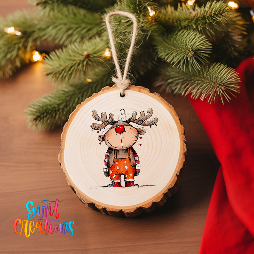 A wooden ornament featuring a cartoon reindeer is hanging on a Christmas tree, surrounded by pine branches and twinkling lights.