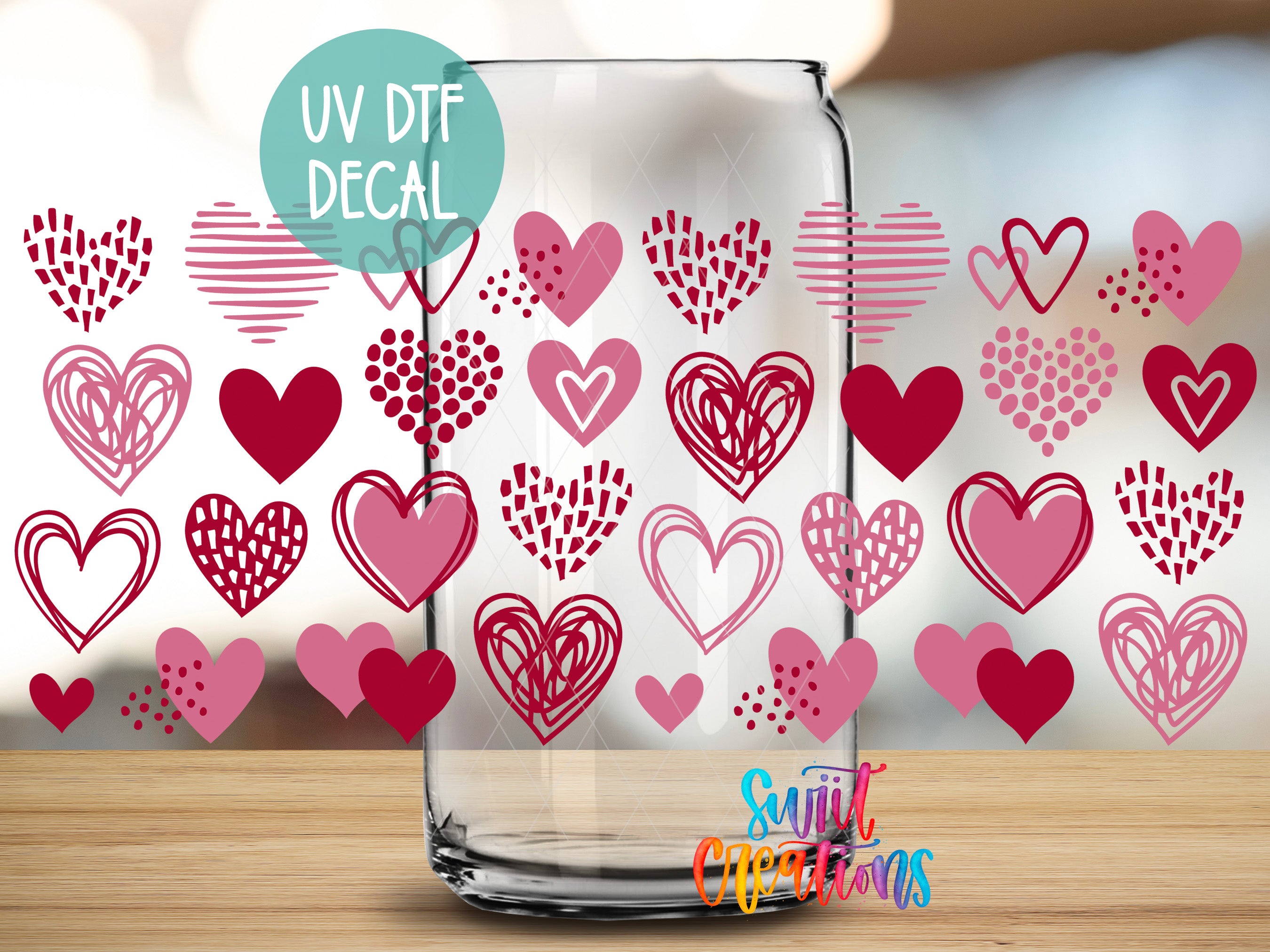 a clear glass jar with a pattern of hearts and hearts on its surface. The jar is placed on a wooden surface, and there is a text overlay that reads "UV Dtf DECAL" and "Sunlit Creations".