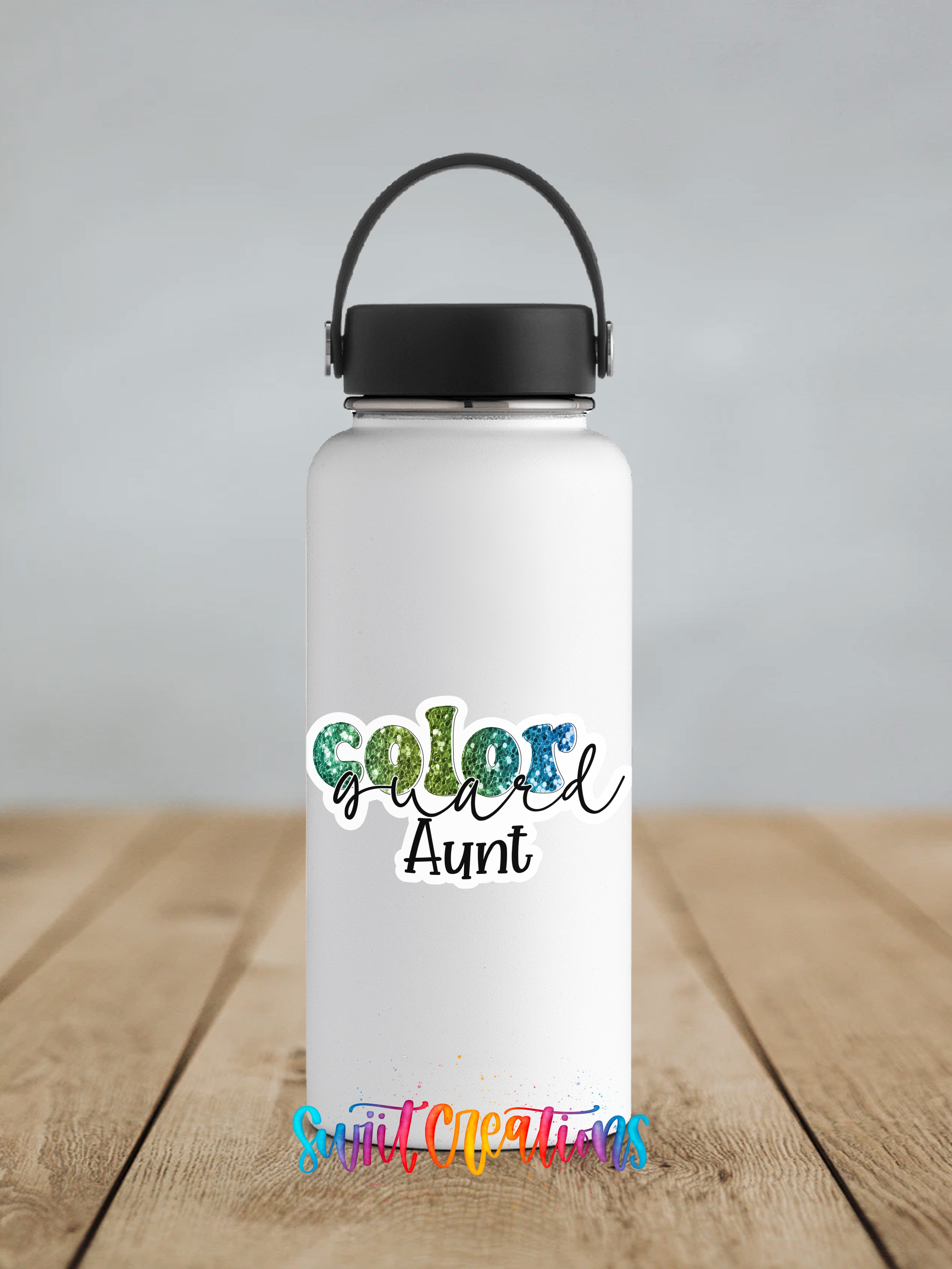 A white water bottle with a black handle and a colorful text logo that says "Color Aunt" on it, placed on a wooden surface.