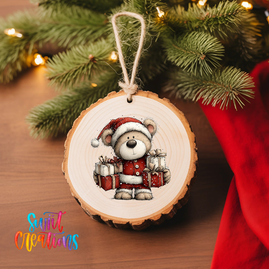 A wooden ornament featuring a teddy bear wearing a Santa hat and holding presents, hanging on a Christmas tree.