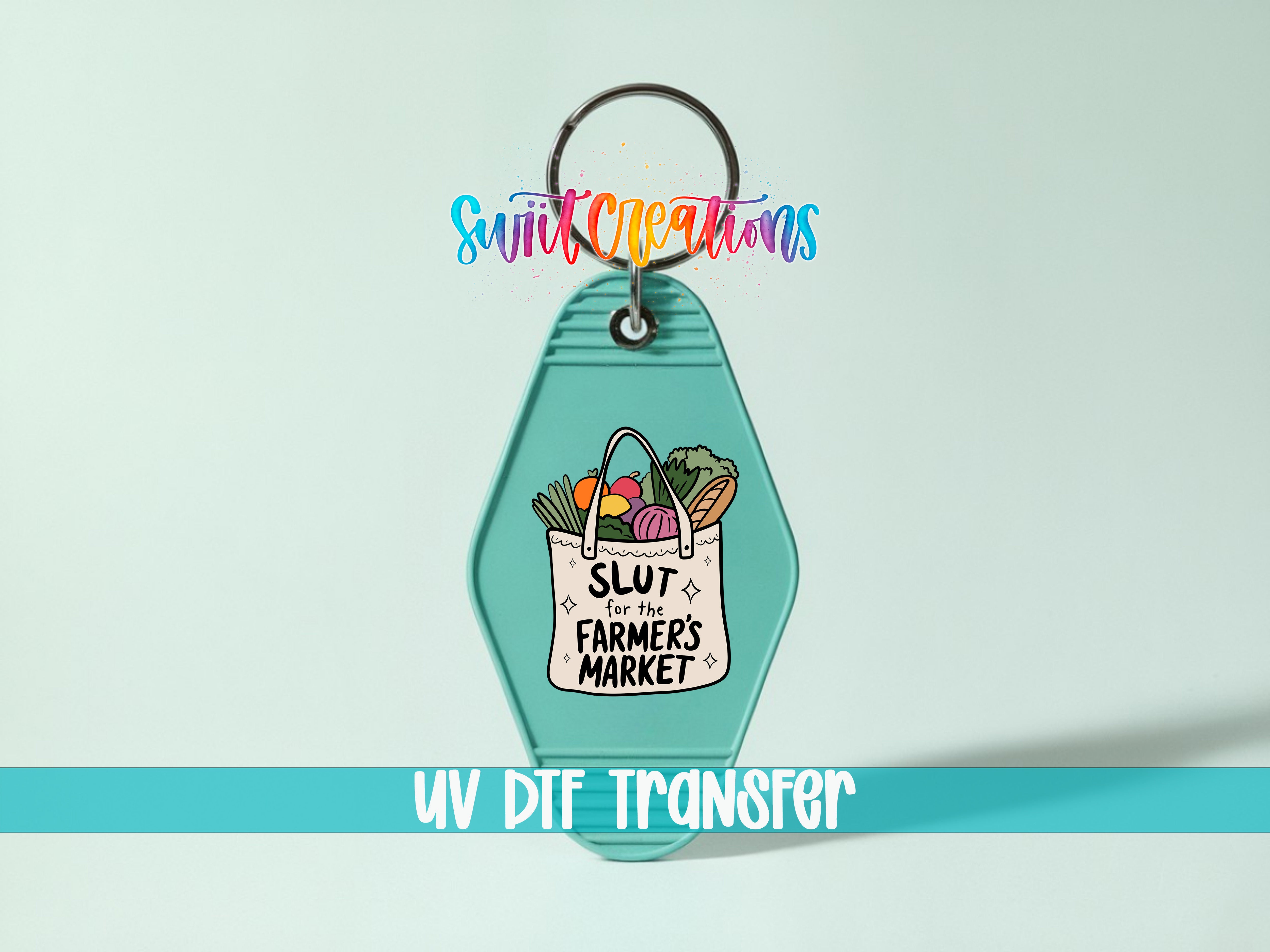 A keychain with a graphic design featuring a bag of produce and the text "SLUT for the farmer's market" printed on it.
