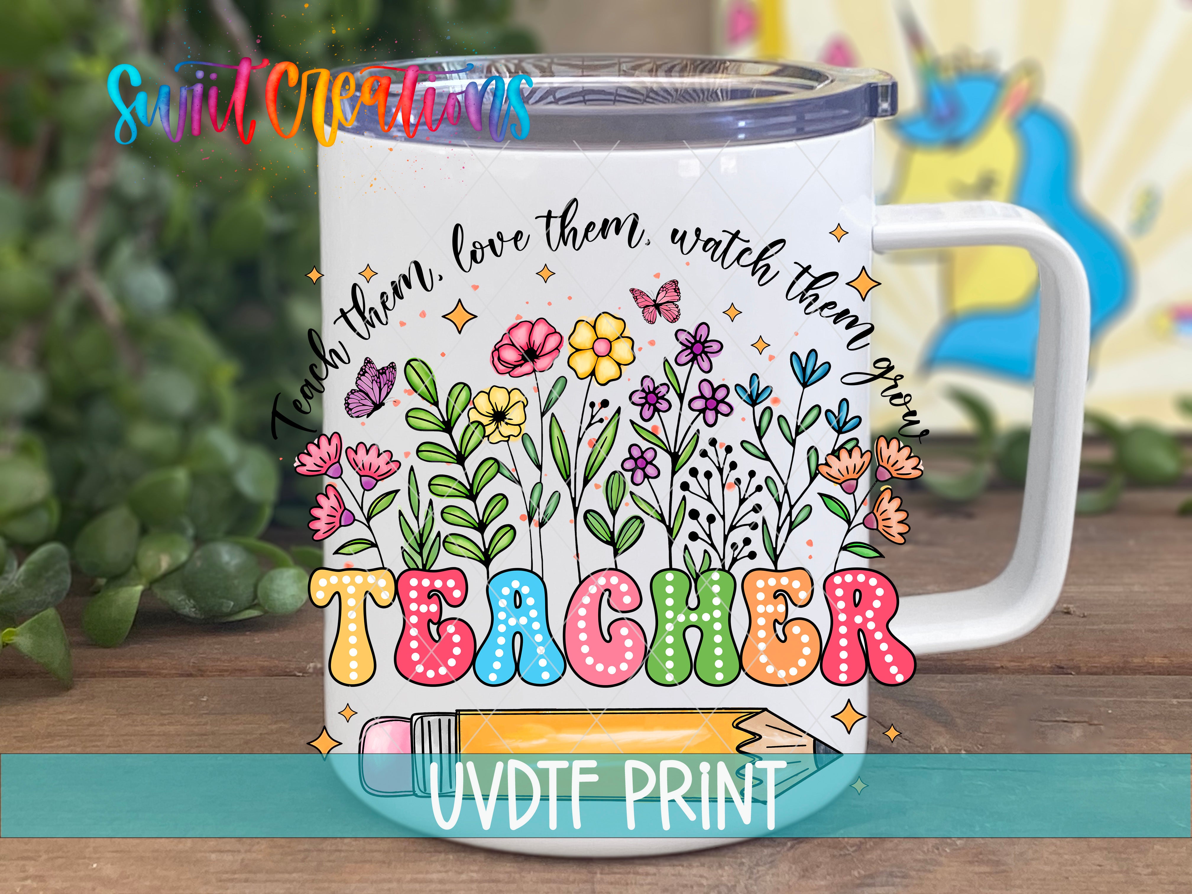 A colorful mug with a floral design and the word "Teacher" printed on it, placed on a wooden surface.