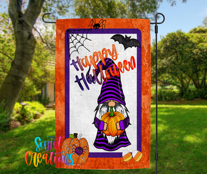 a Halloween-themed garden flag with a gnome holding a pumpkin and a spider web.
