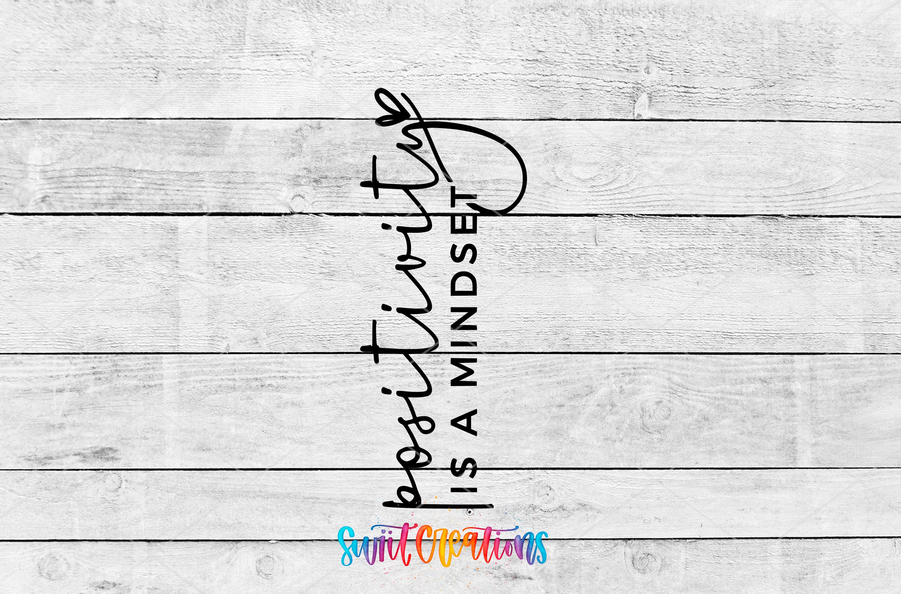The image is a white wooden background with a motivational quote in black text that reads "positivity is a mindset".