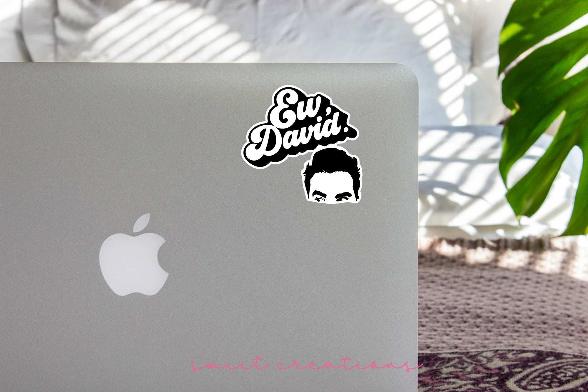 a laptop with a sticker of a man's face