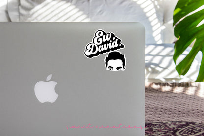 a laptop with a sticker of a man's face